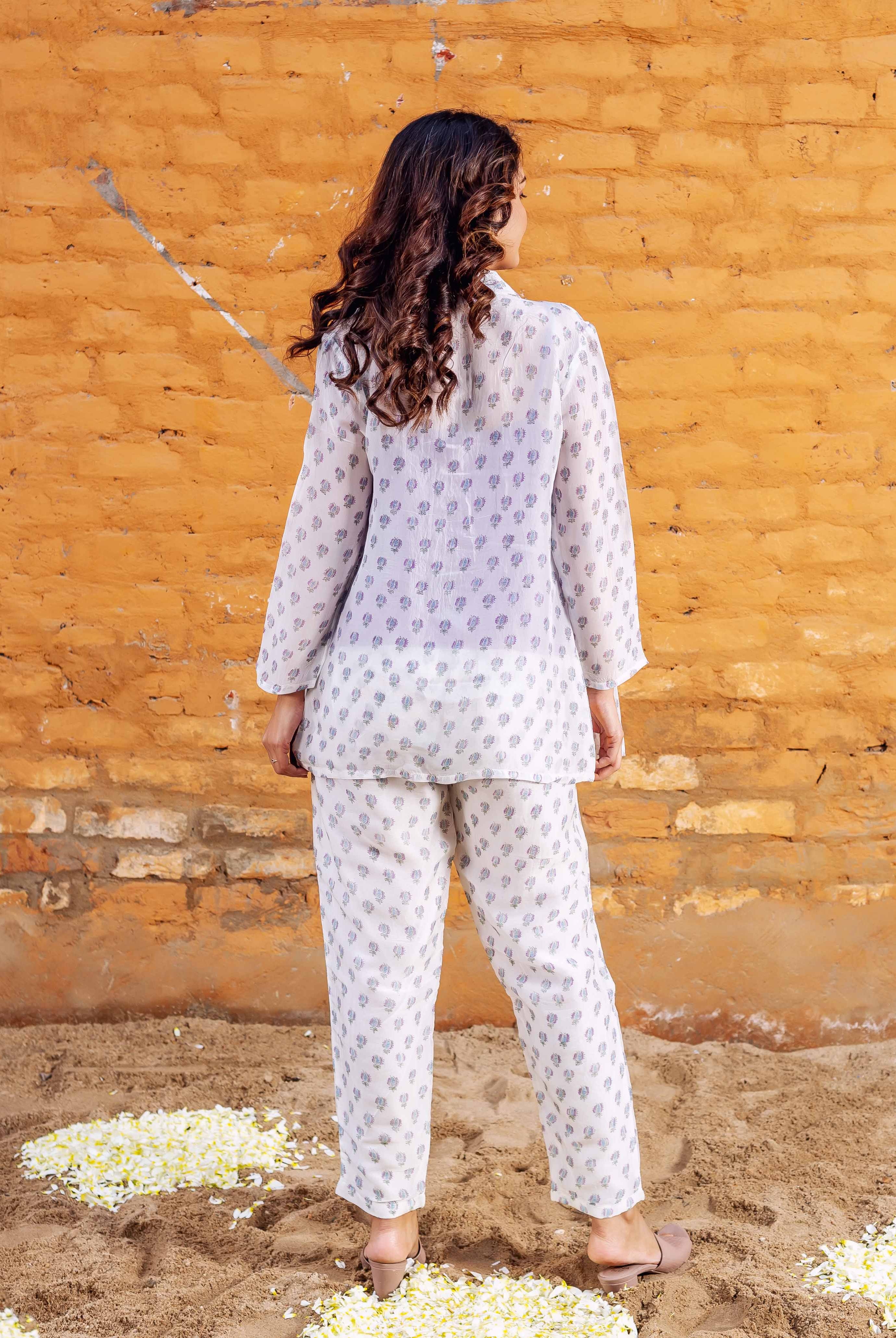 Model's back displays a full white block-printed co-ord set with blue floral patterns.