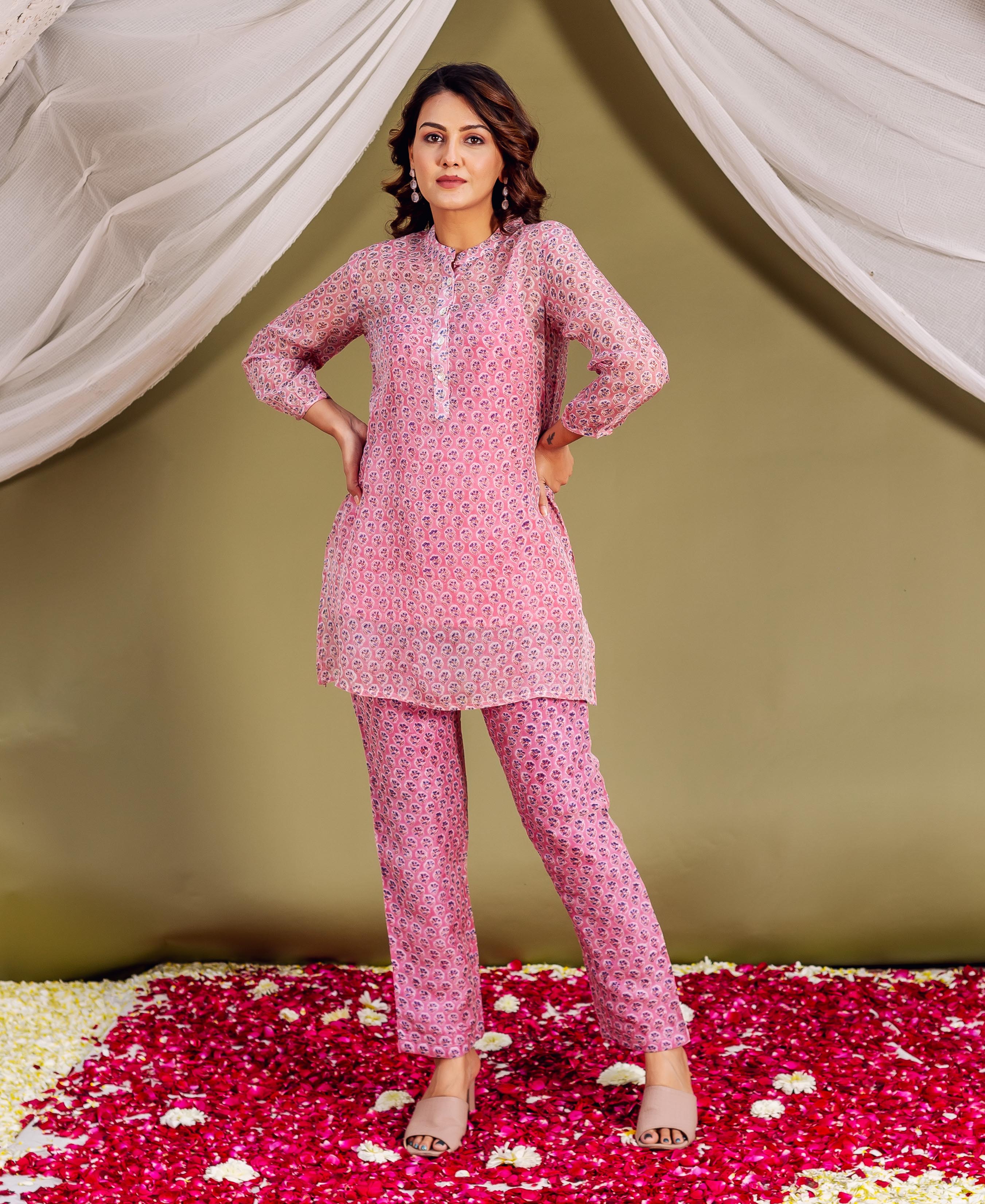 Full-length model wearing a pink hand-block-printed ethnic tunic and matching pants set.