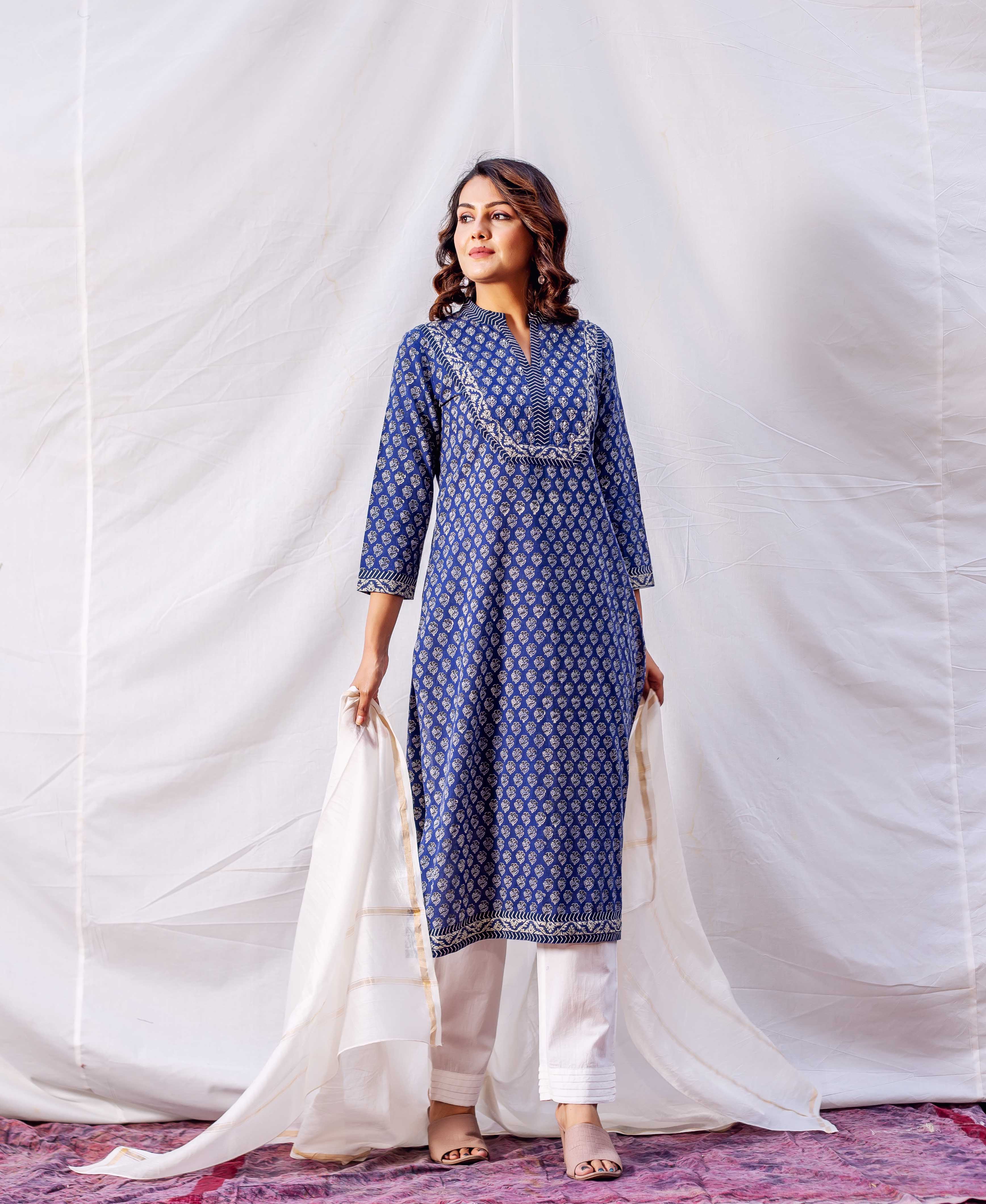 Model wearing indigo hand-block-printed kurta with white embroidered yoke, matching pants, and dupatta.