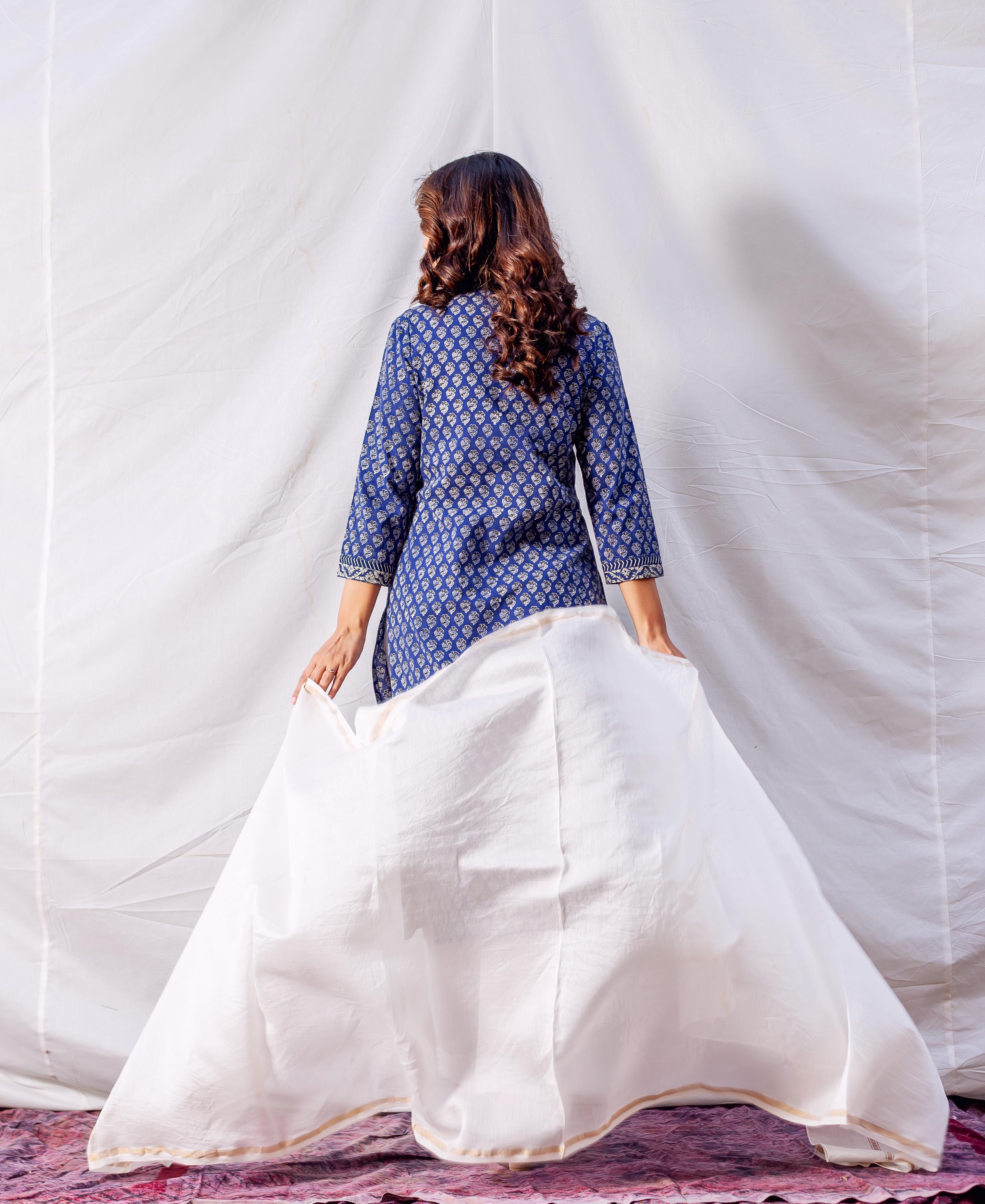 Back view of model wearing indigo hand block printed straight kurta with white dupatta.