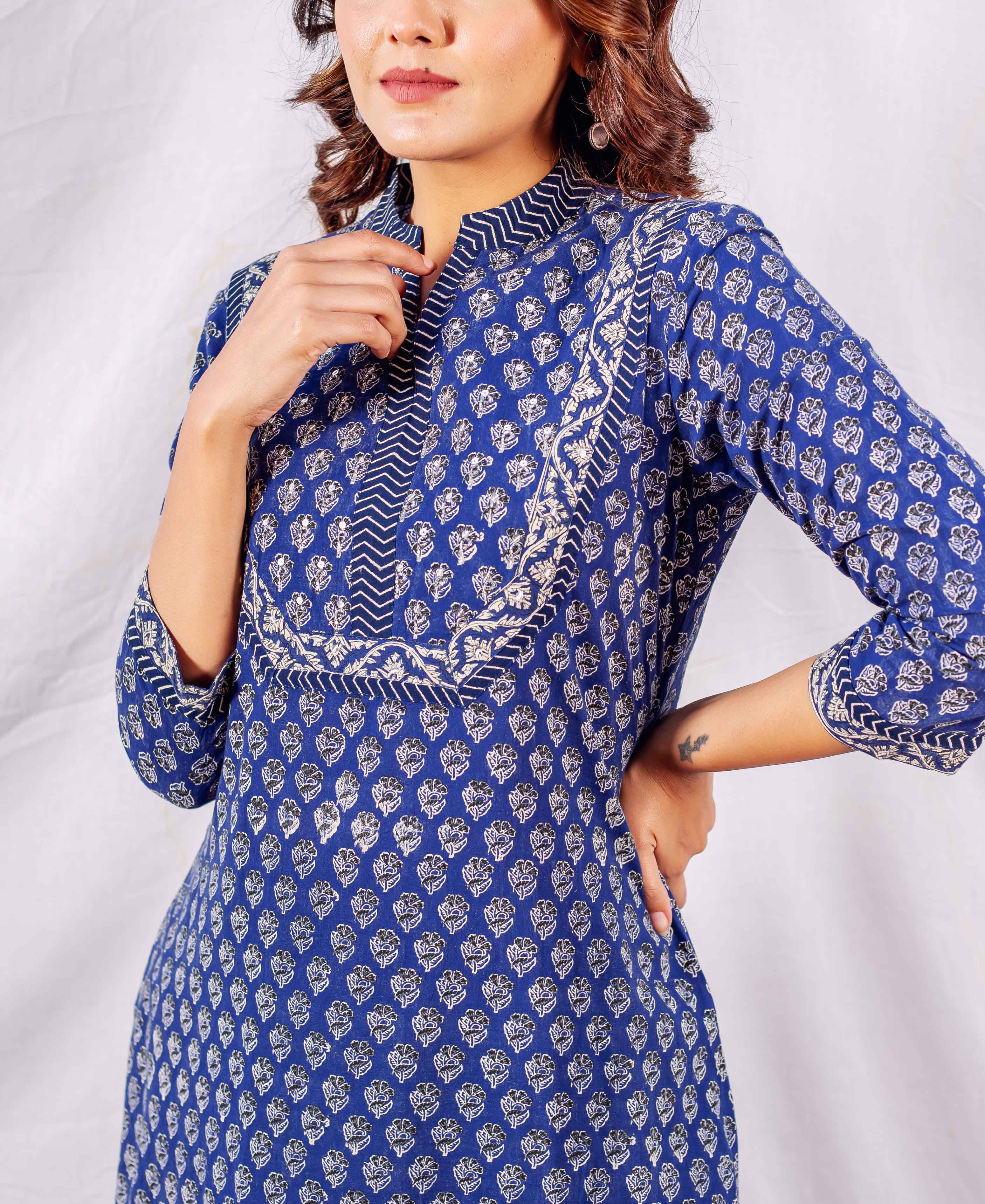 Front view of model wearing indigo hand block printed kurta with embroidered yoke.