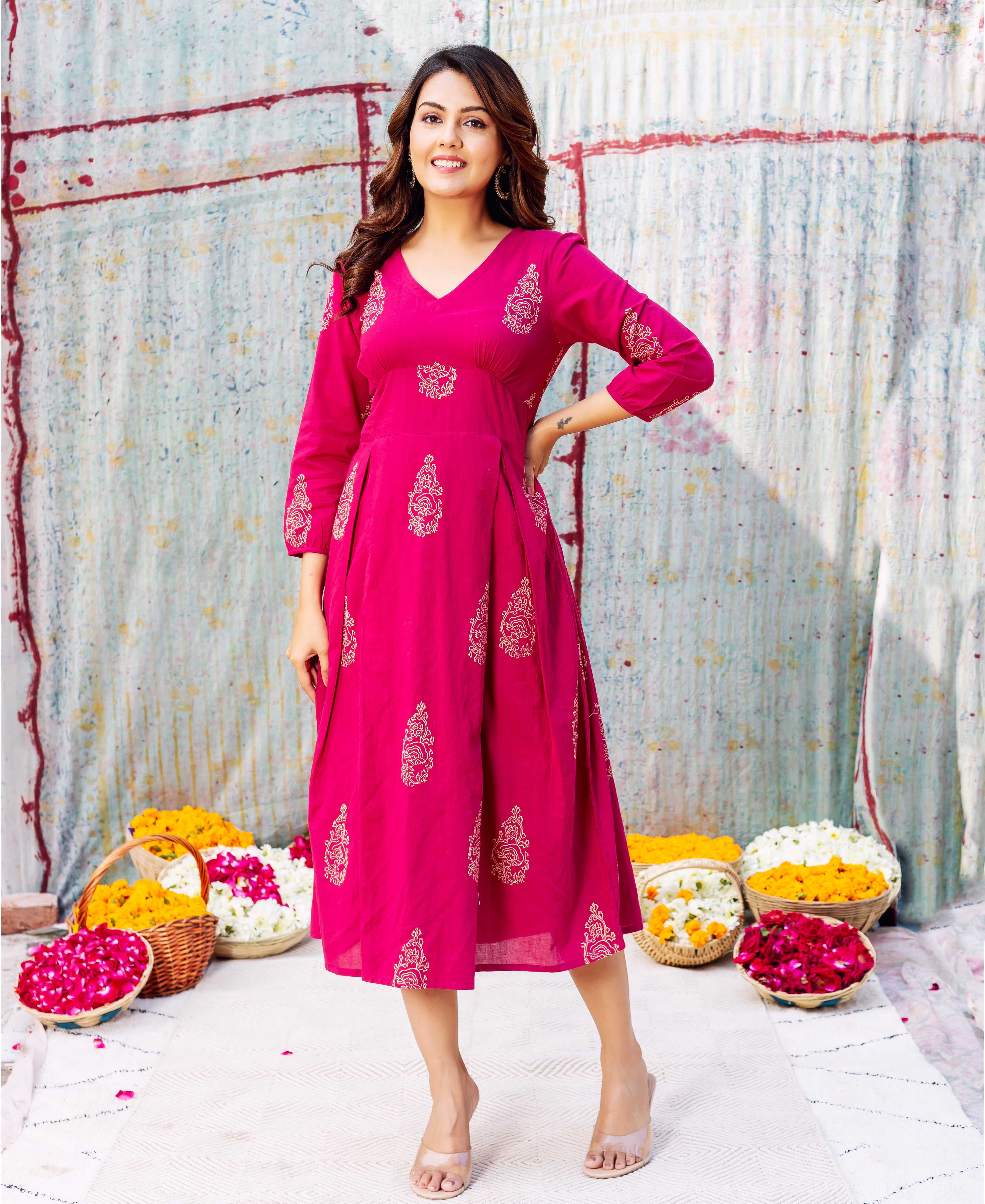Model in a fuchsia hand-block-printed ethnic Stella Dress with intricate golden patterns.