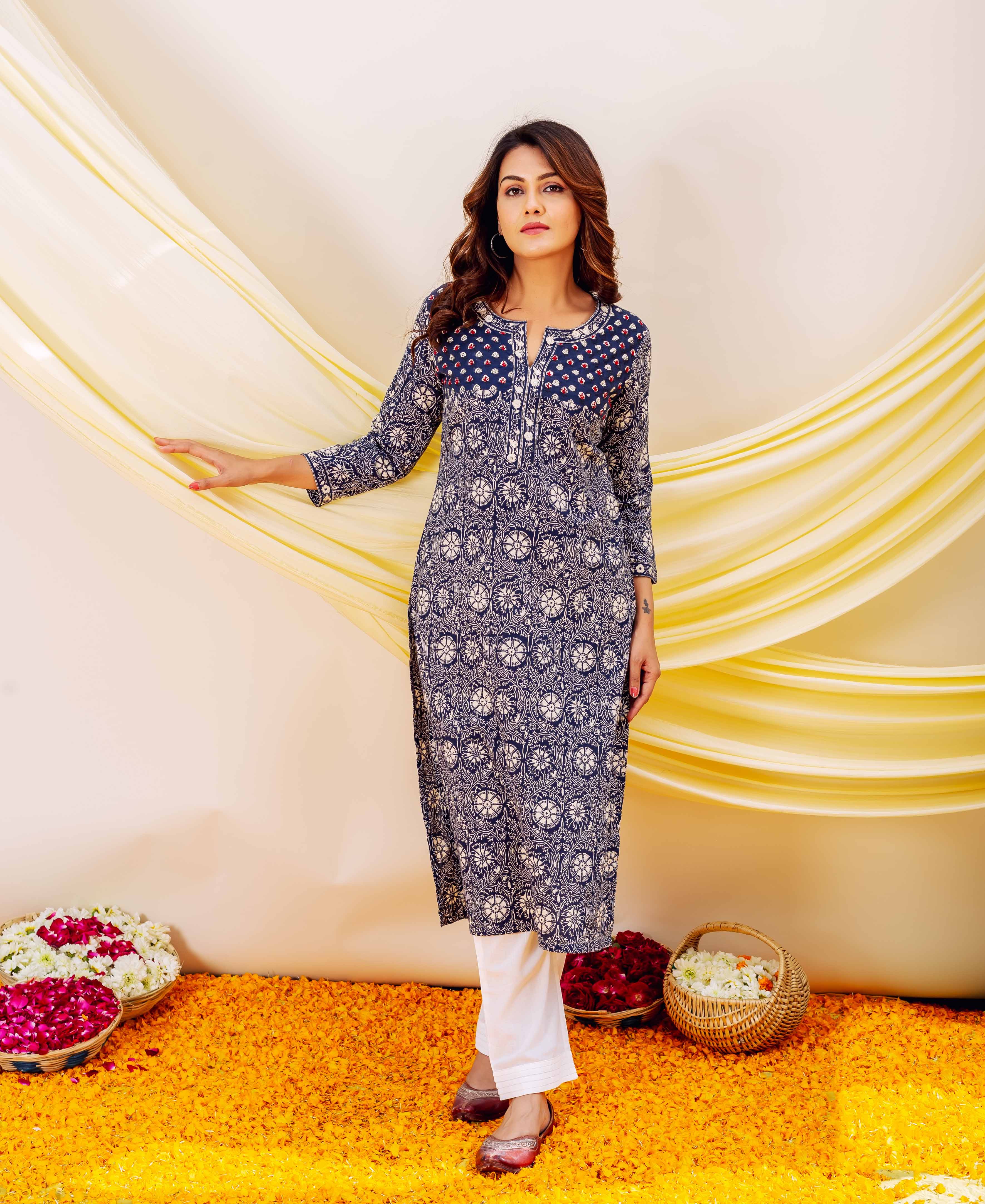 Full-length front view of model in indigo straight kurta with white floral print and embroidered yoke.