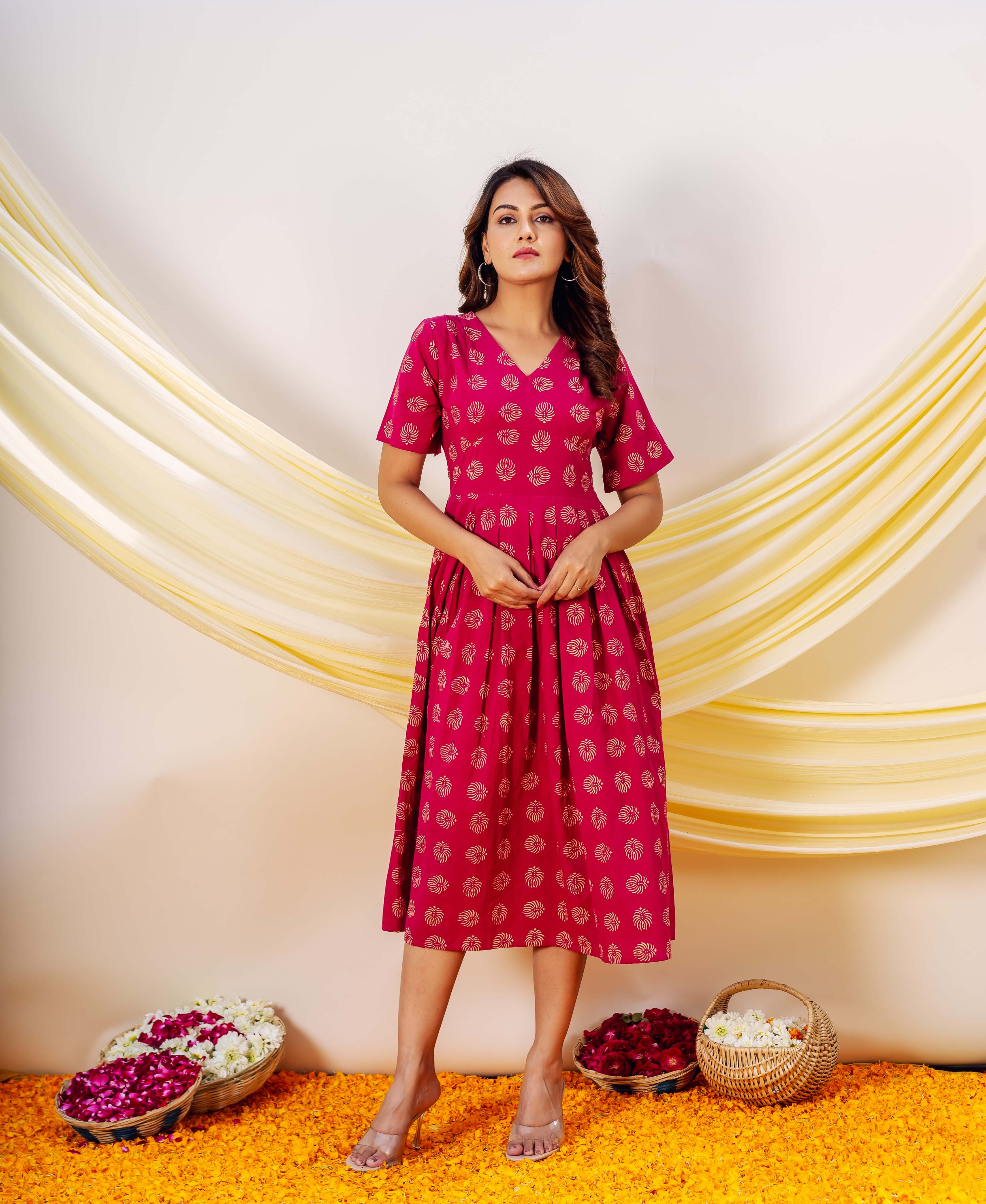 Full-look front shot of model wearing a magenta V-neck midi dress with gold ethnic block print.