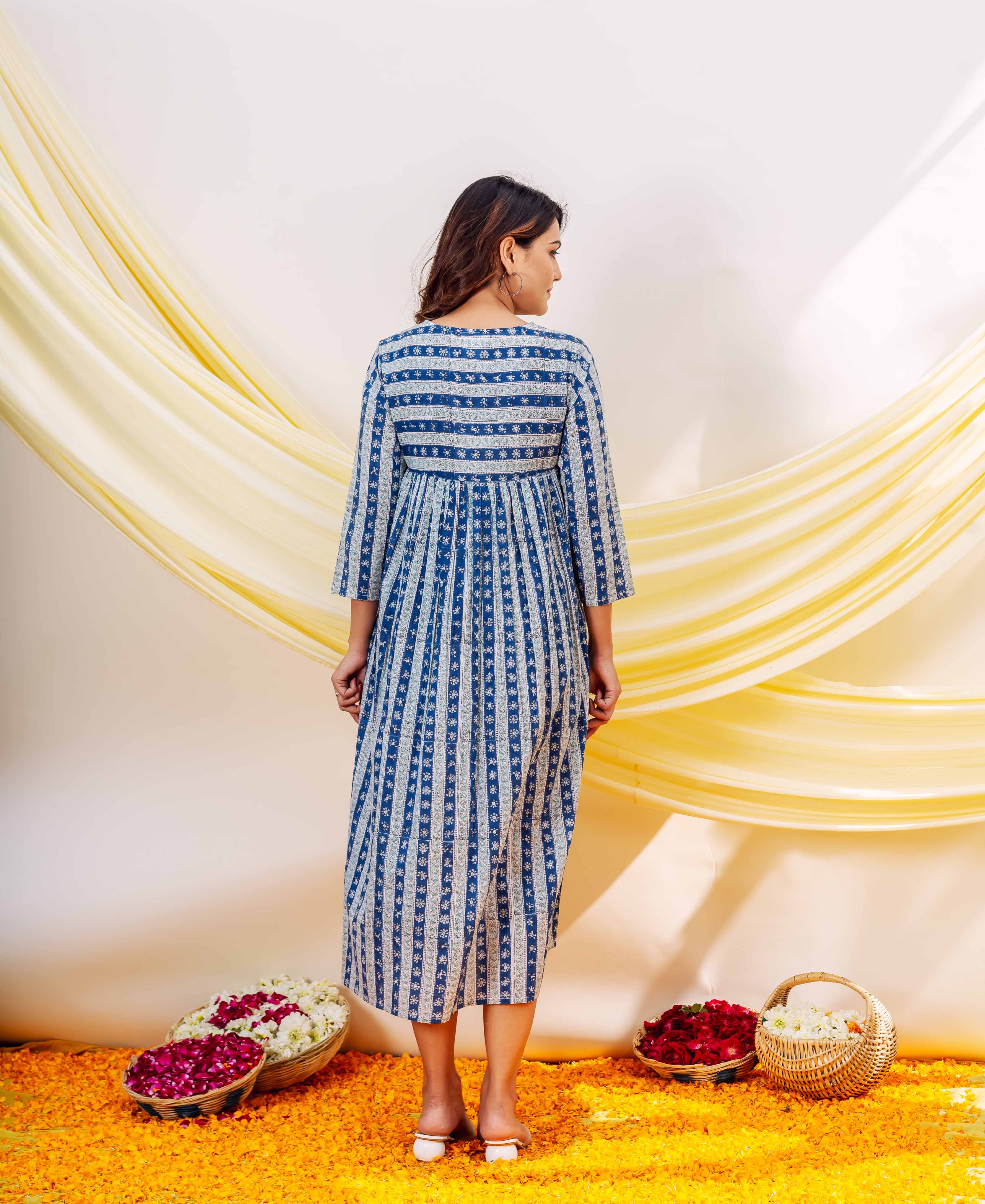Back of woman in indigo blue and white hand-block printed striped dress.