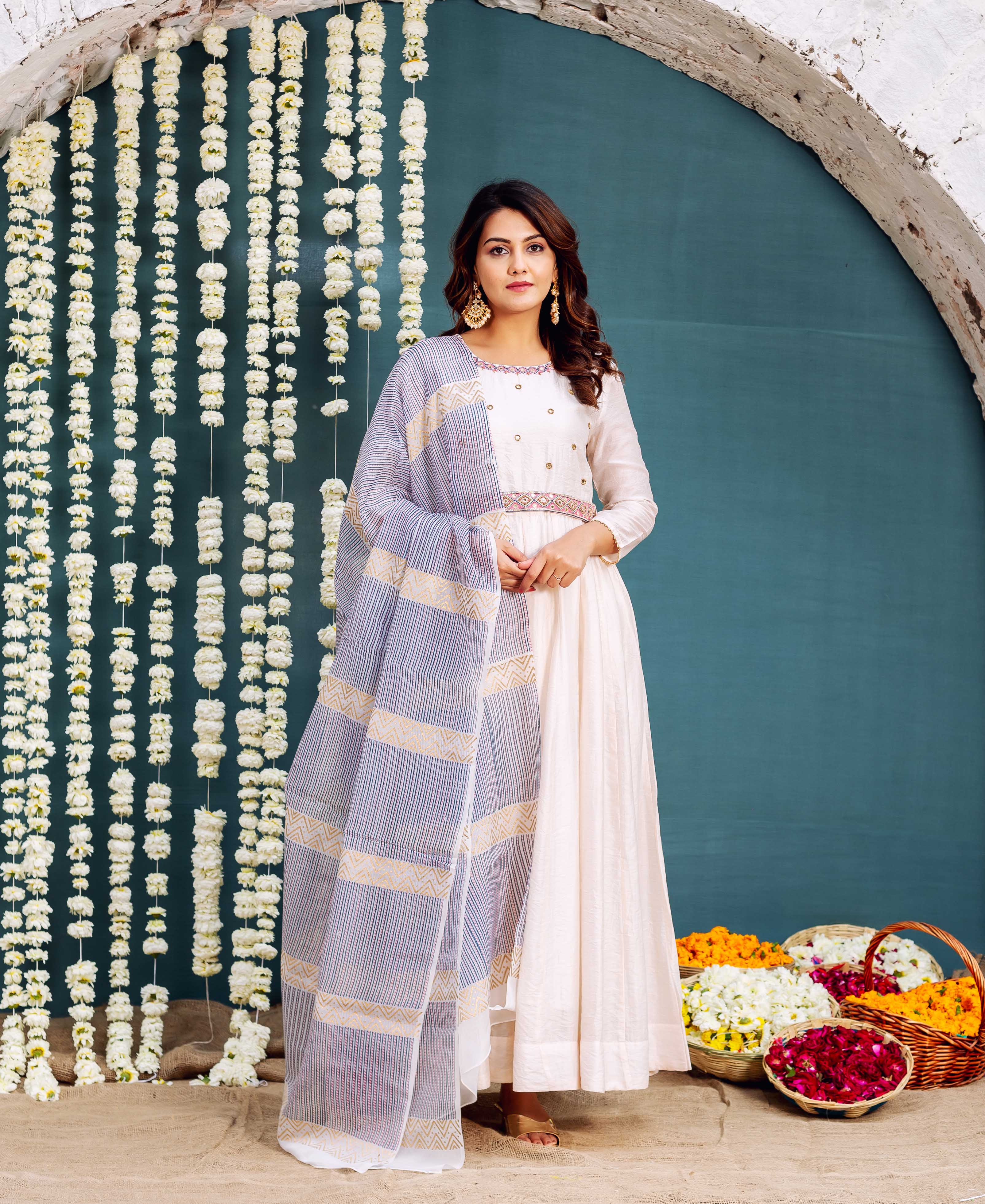 Model in off-white Anarkali dress with embroidered belt and blue striped hand-block-printed dupatta.