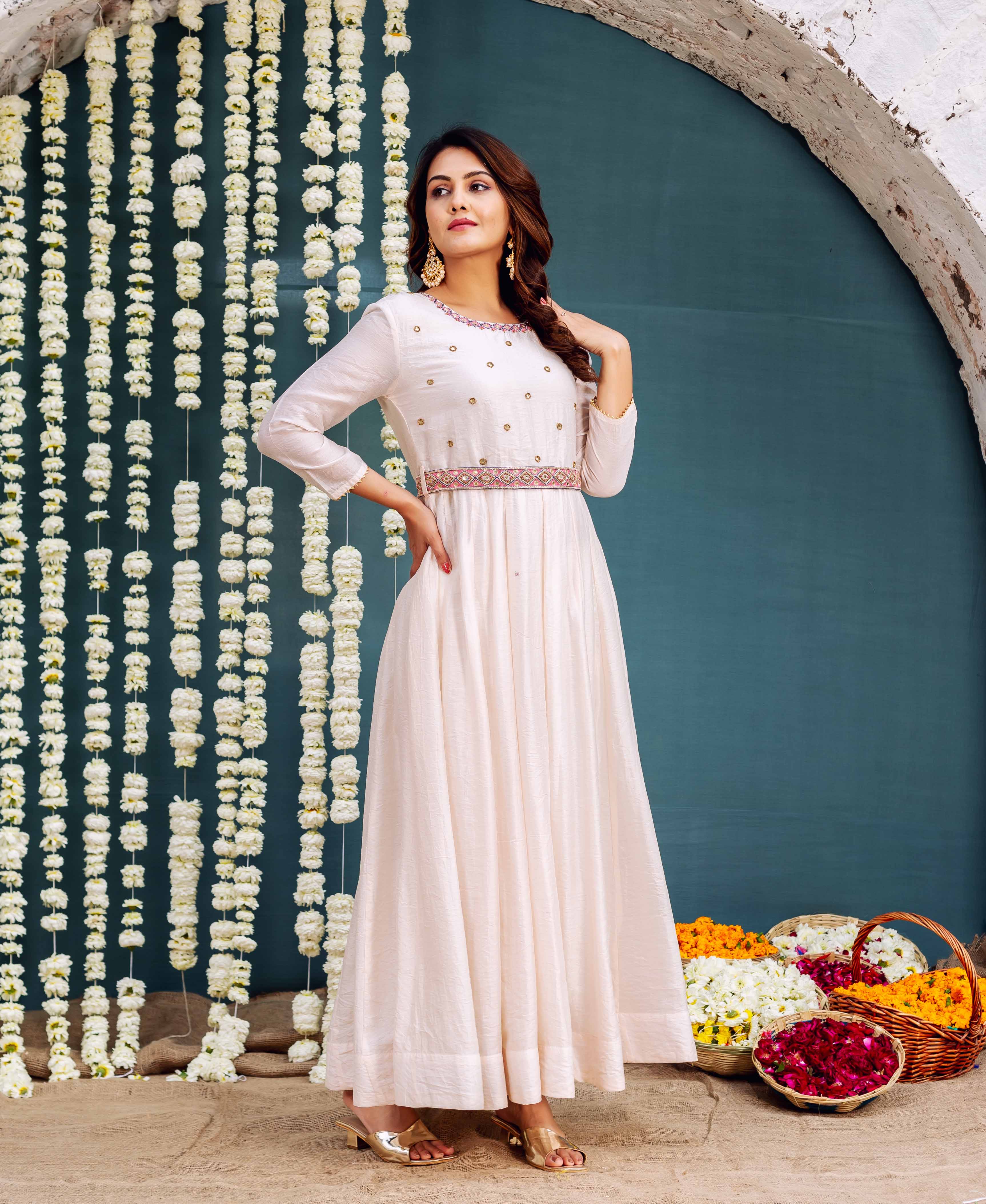 Light cream Anarkali dress on model, featuring delicate gold motifs and an ethnic hand-block printed belt.
