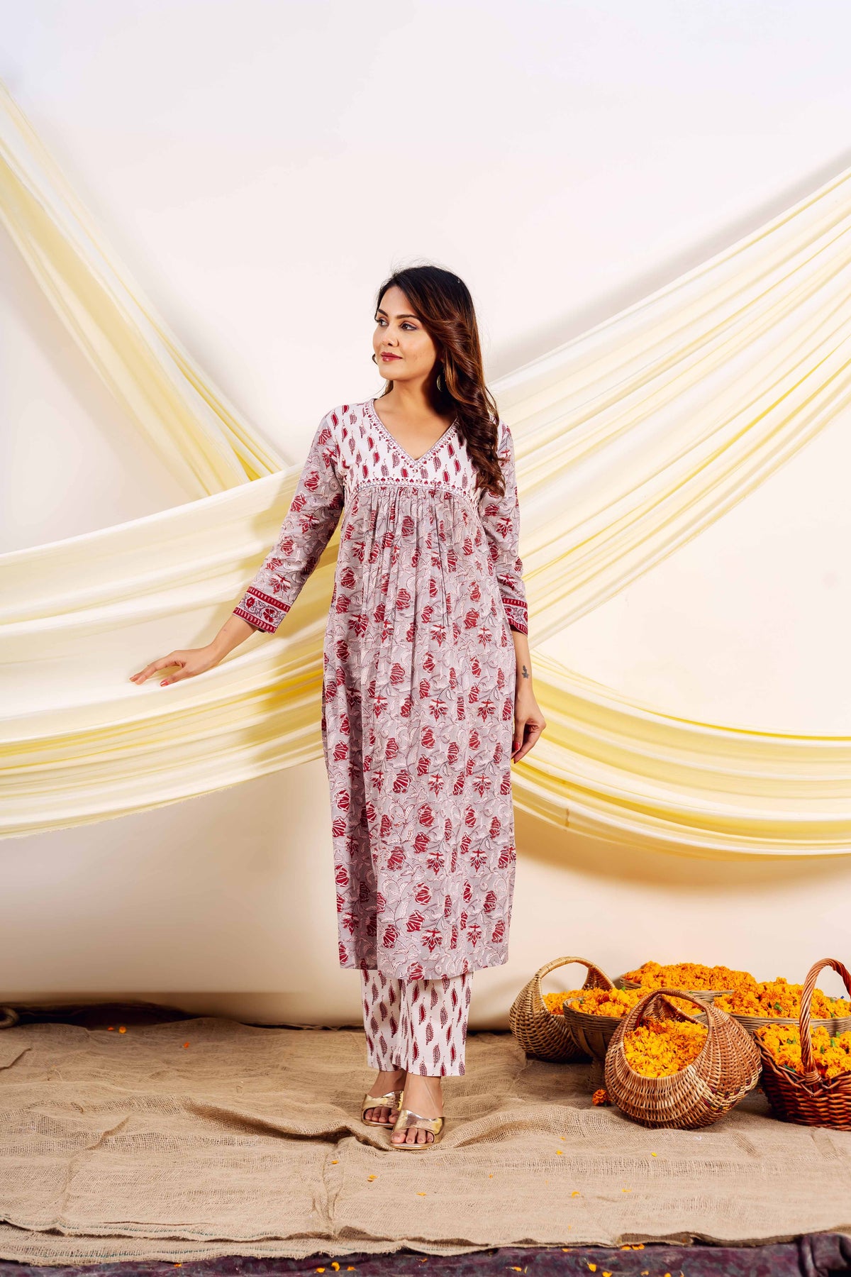Full front view model in grey and red hand-block printed Naira kurta set.