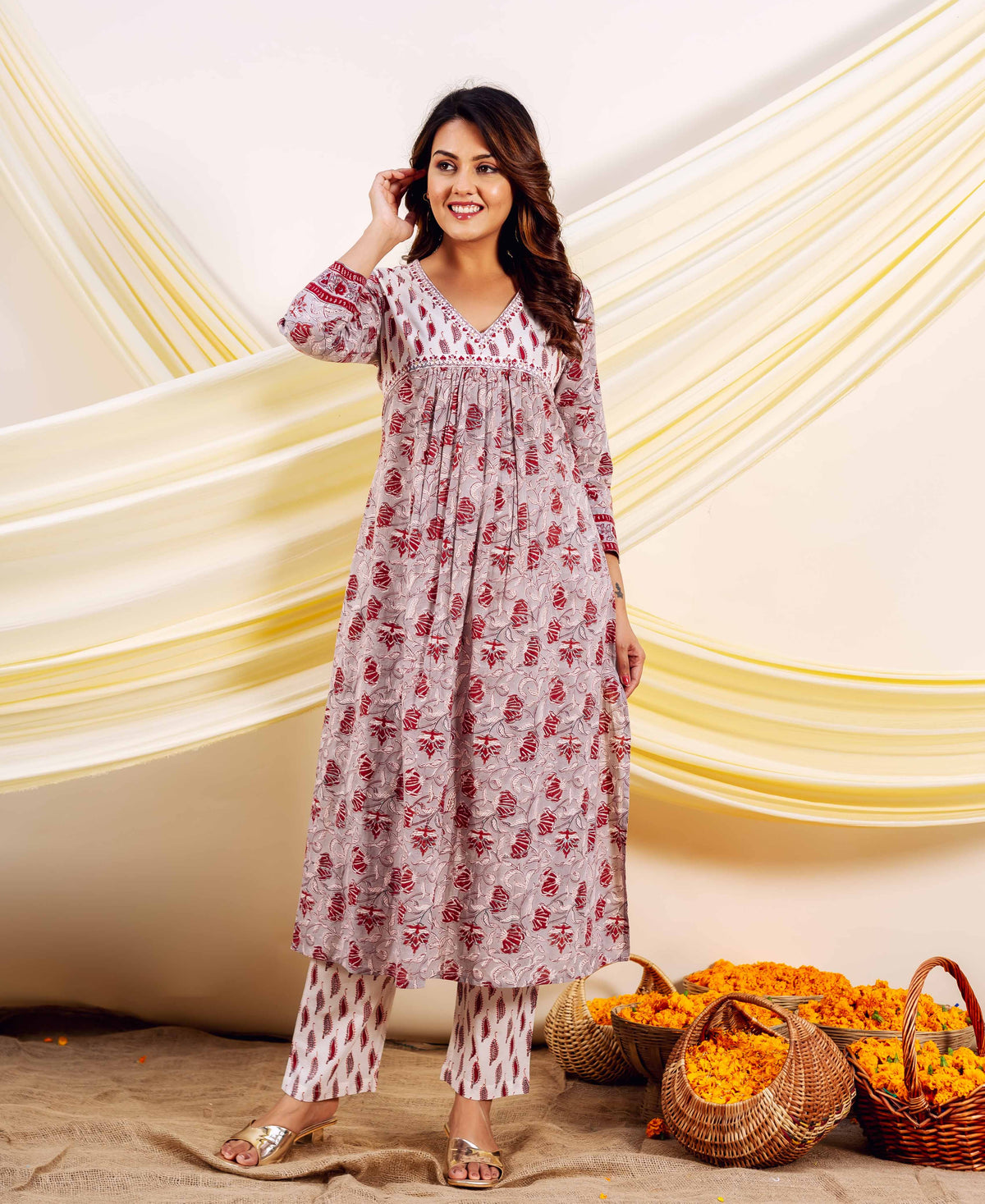 Front full look of model wearing a grey and red hand-block printed Naira kurta set.
