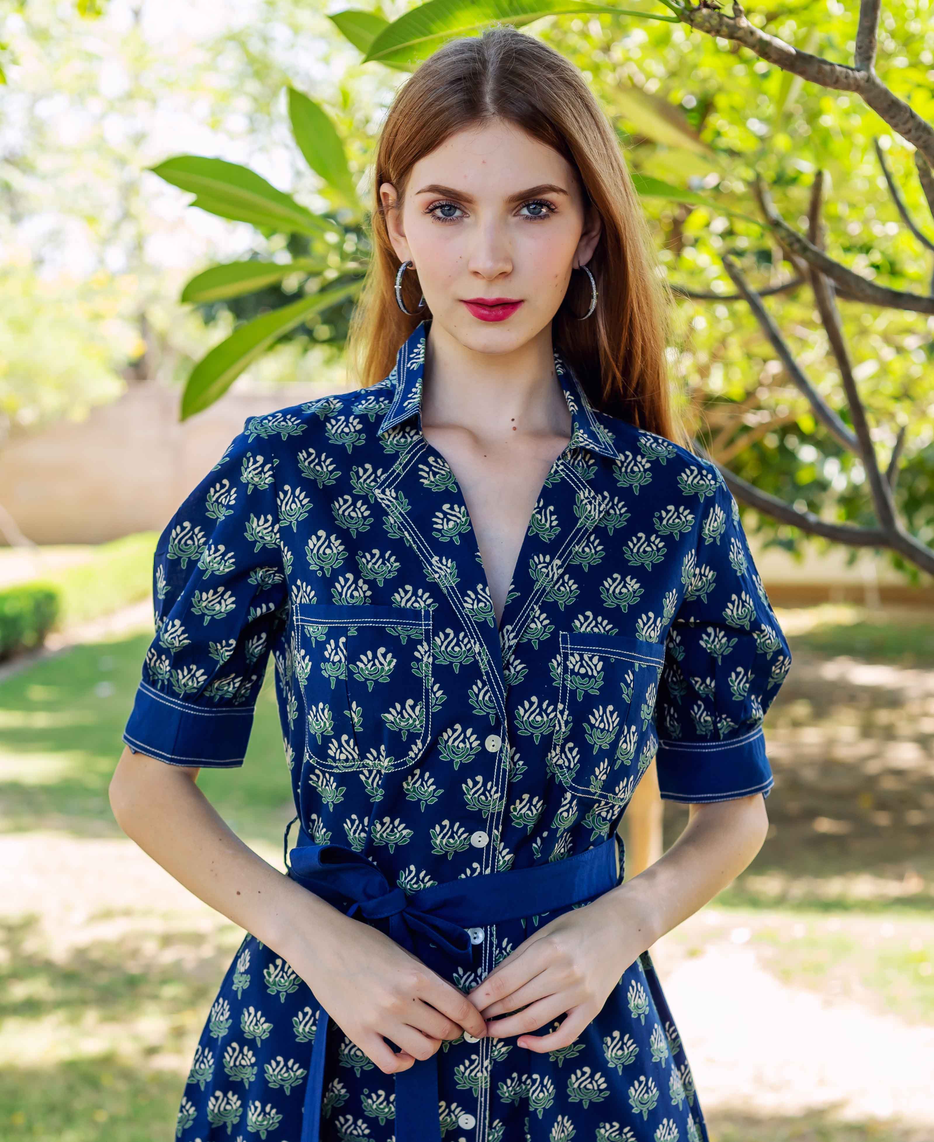 Front view model wearing indigo blue hand block printed shirtdress with floral motifs.