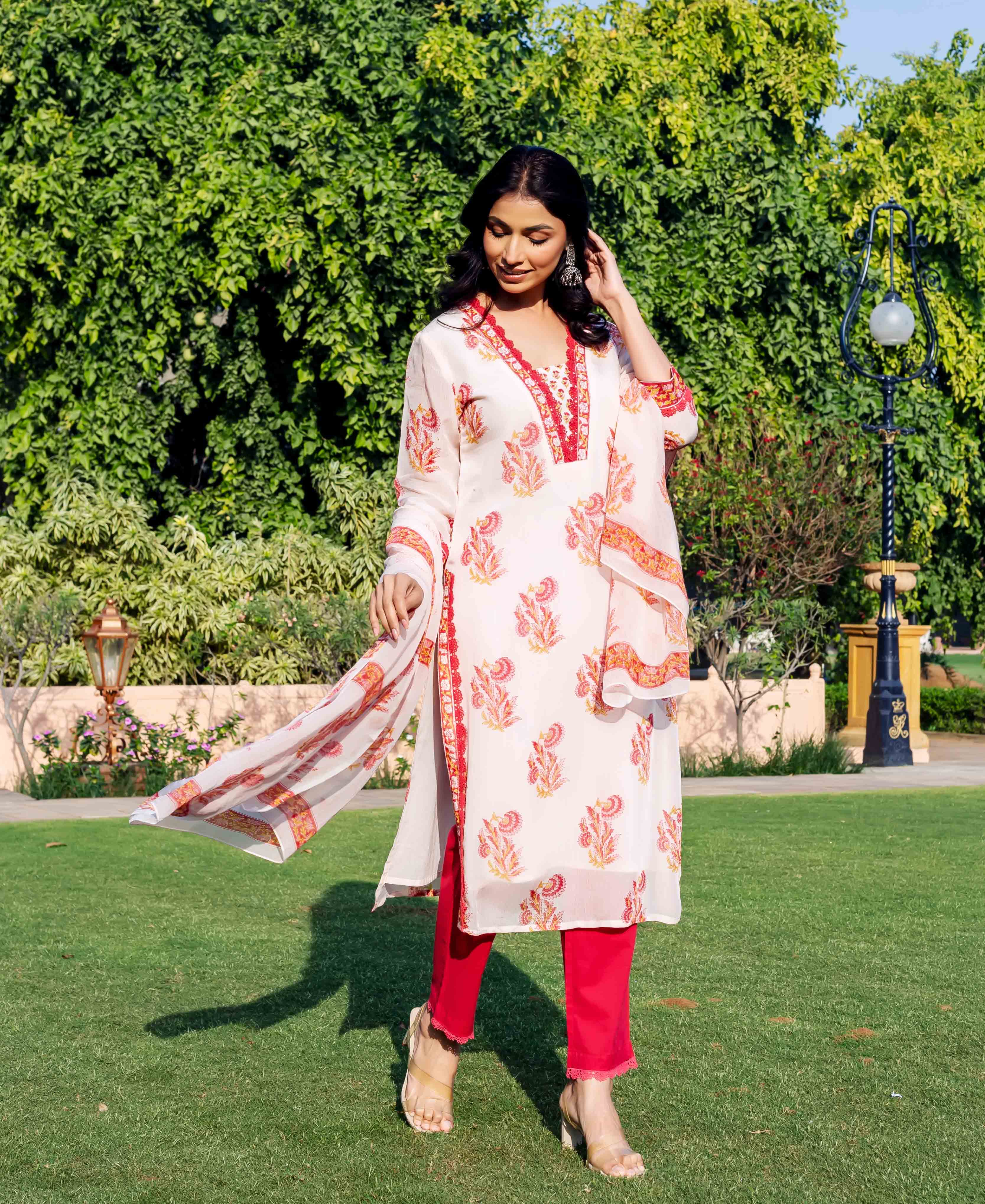 Model in off-white organza kurta set with red ethnic hand-block floral print.