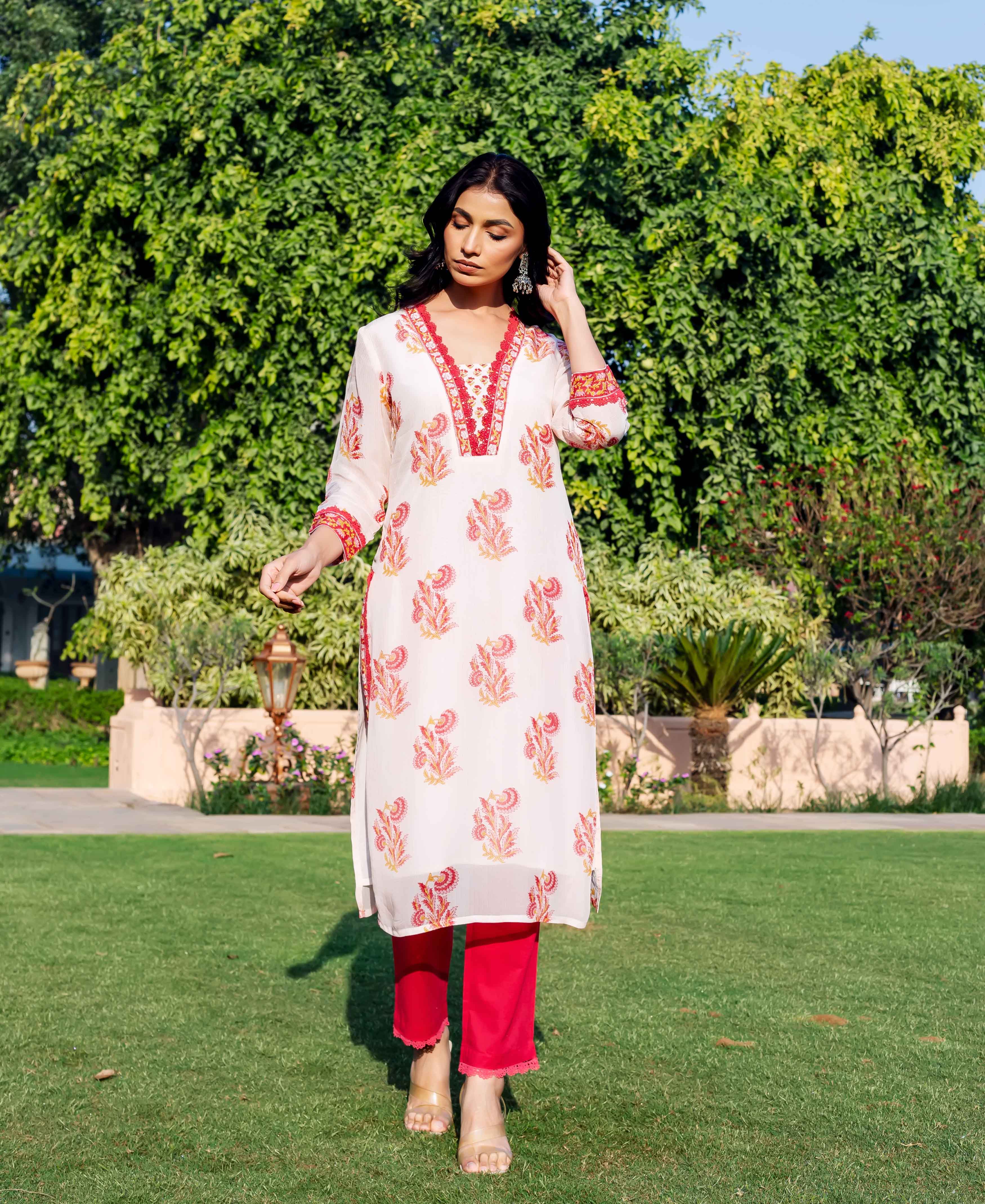 Model in an off-white organza kurta with red misprint hand-block print and red pants.
