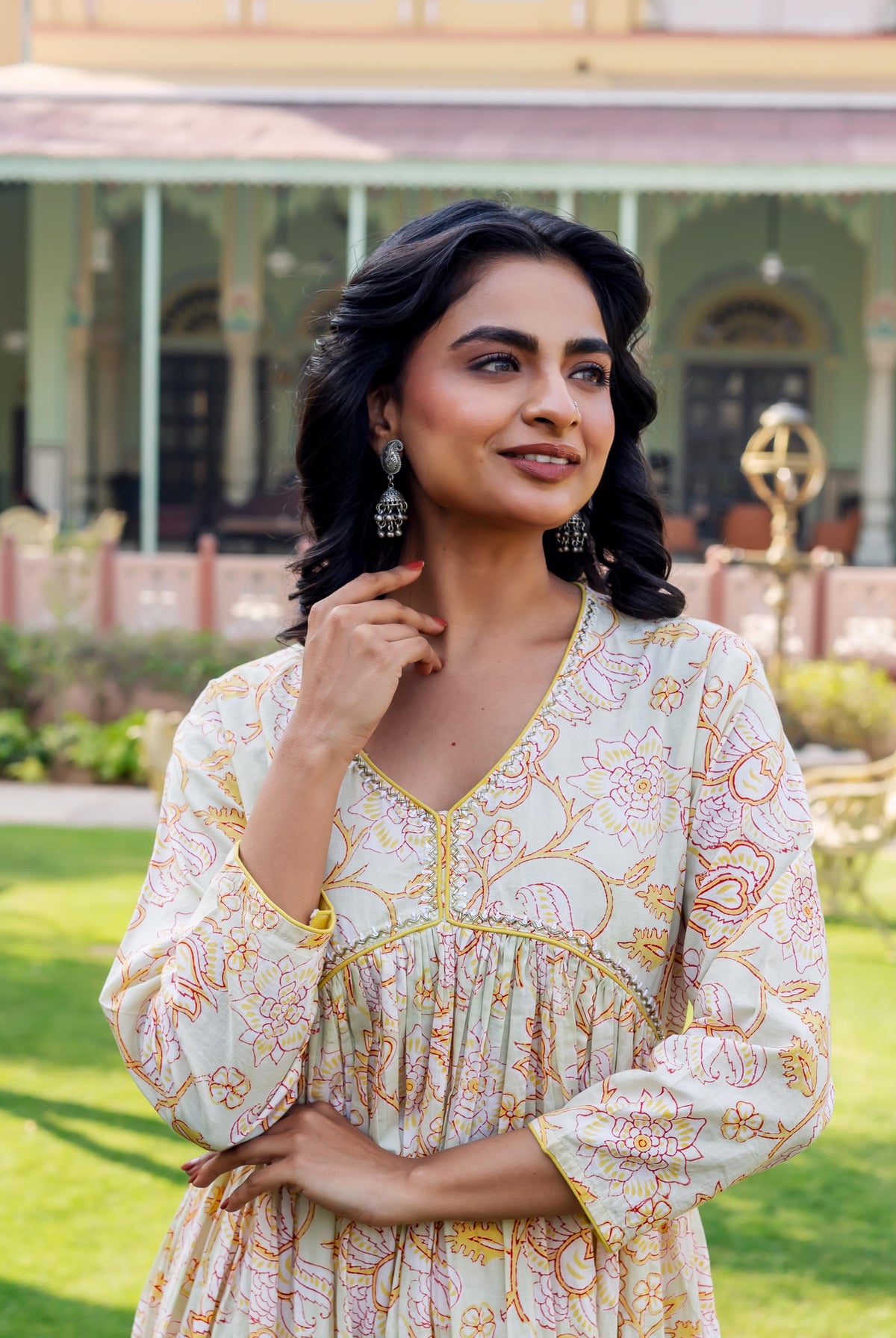 Model in misprint Savera floral cotton kurta, light green with yellow and red hand-block print.