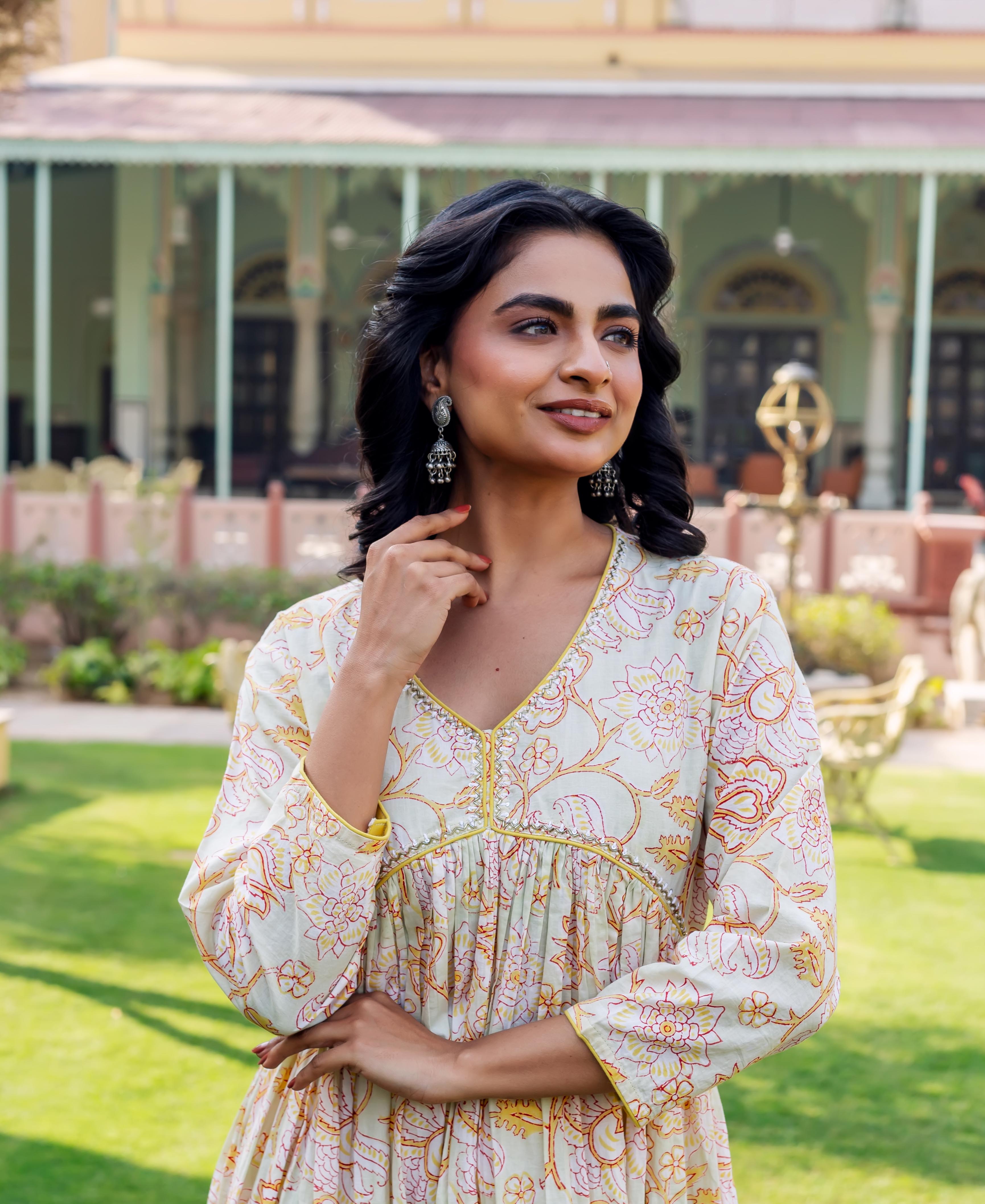 Model in misprint Savera floral cotton kurta, light green with yellow and red hand-block print.