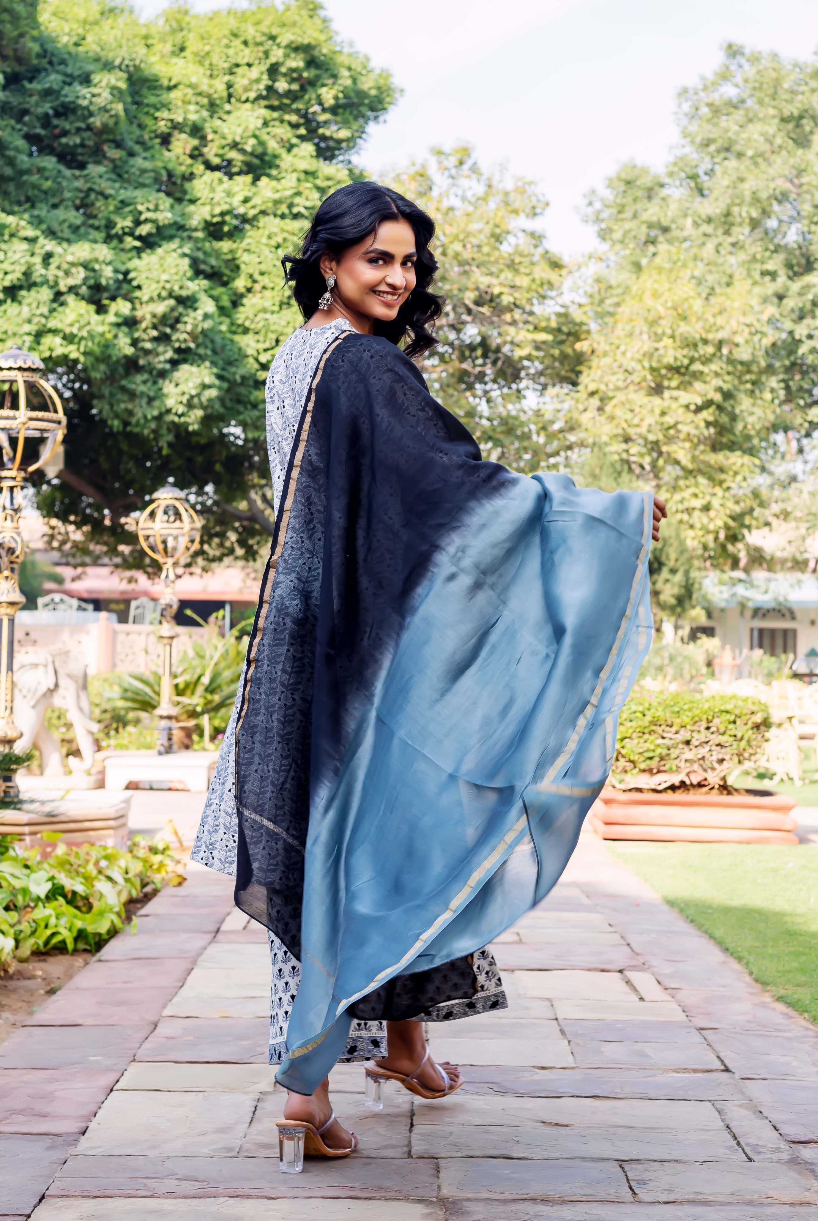 Model looking over shoulder, wearing a block-printed kurta and flowing black-to-blue ombre dupatta.