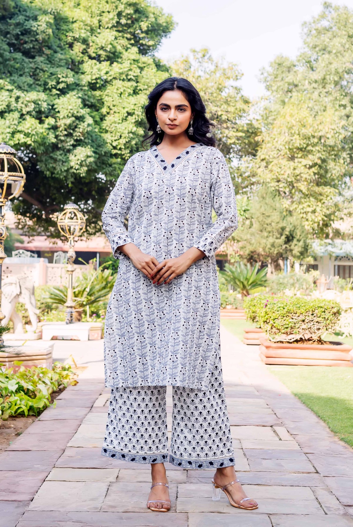 Front view model in white and blue leaf block printed kurta and geometric palazzo pants.