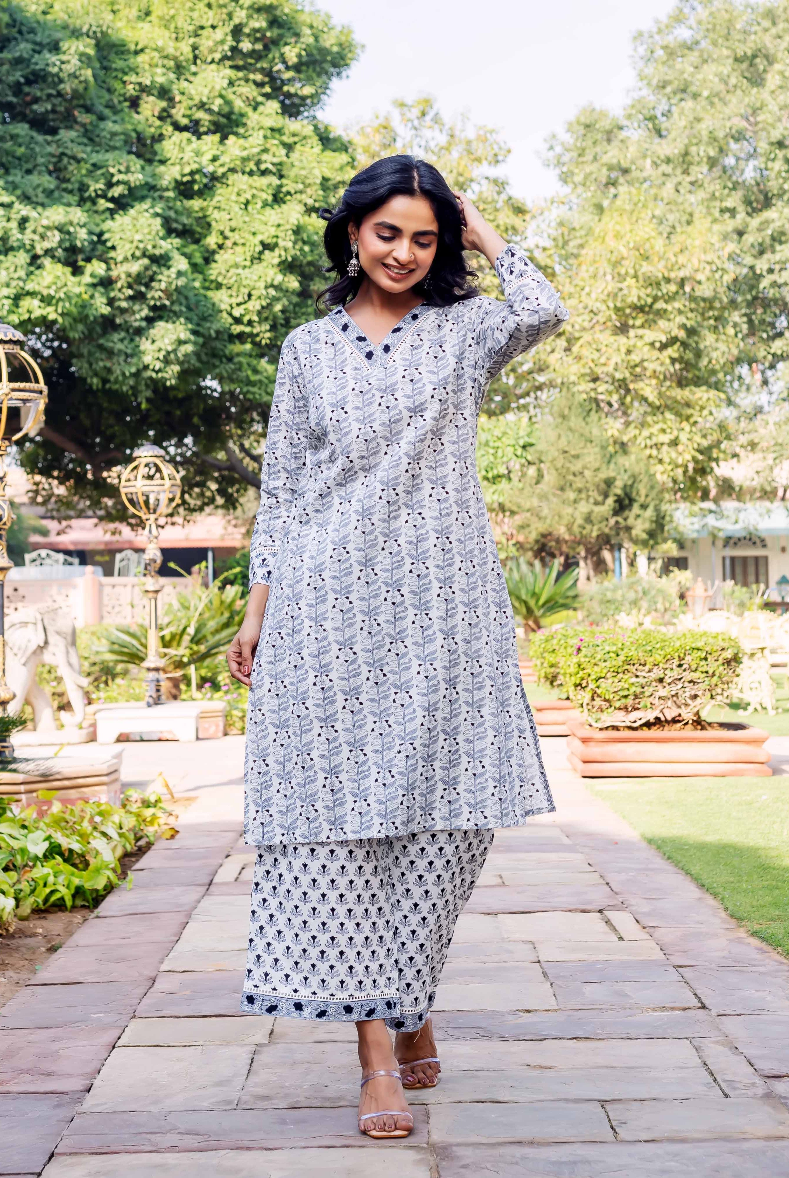 Front full look of a model in a white and blue block-printed cotton kurta set.