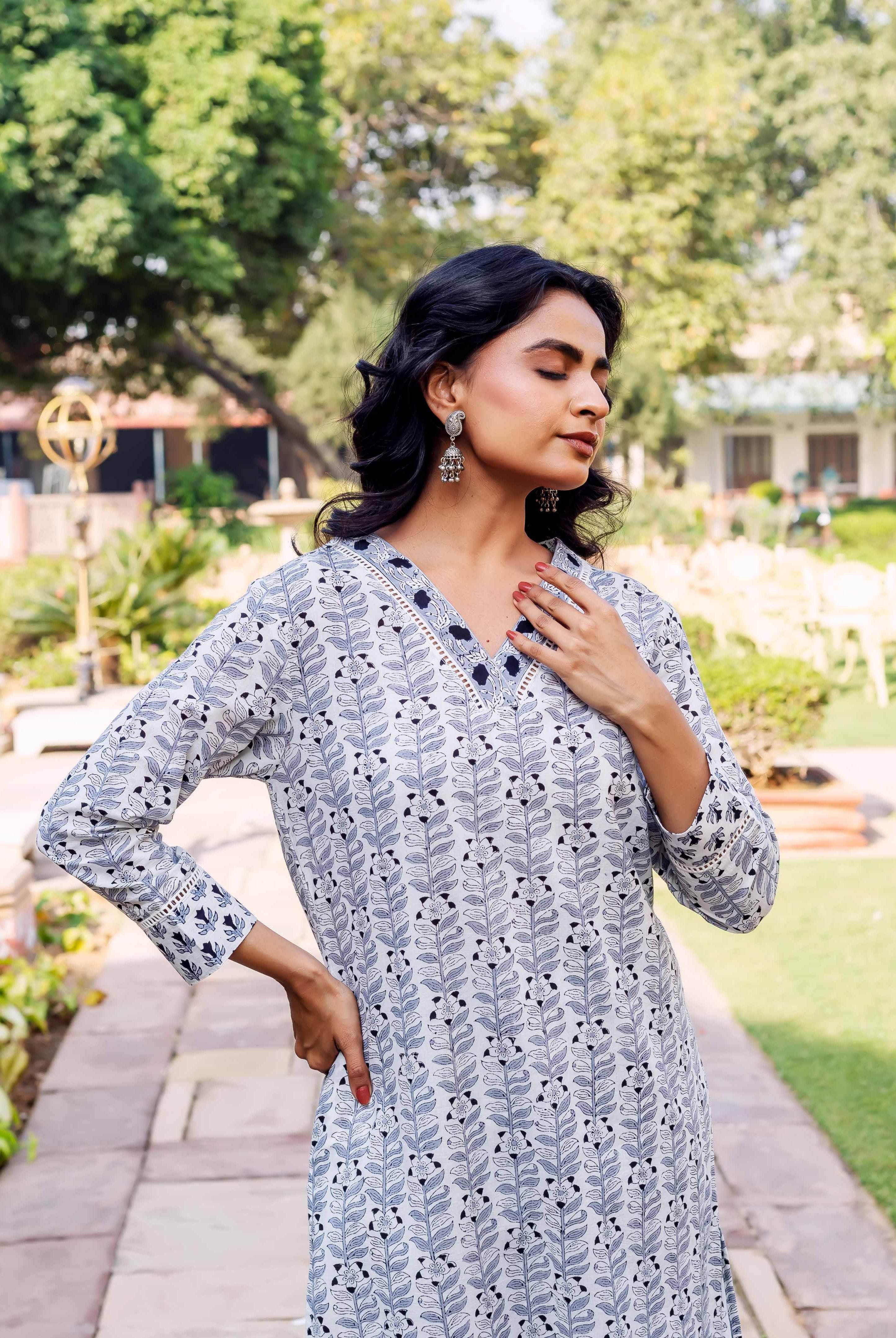 Long-sleeved white and blue block-printed cotton kurta with vertical leaf pattern and V-neck.
