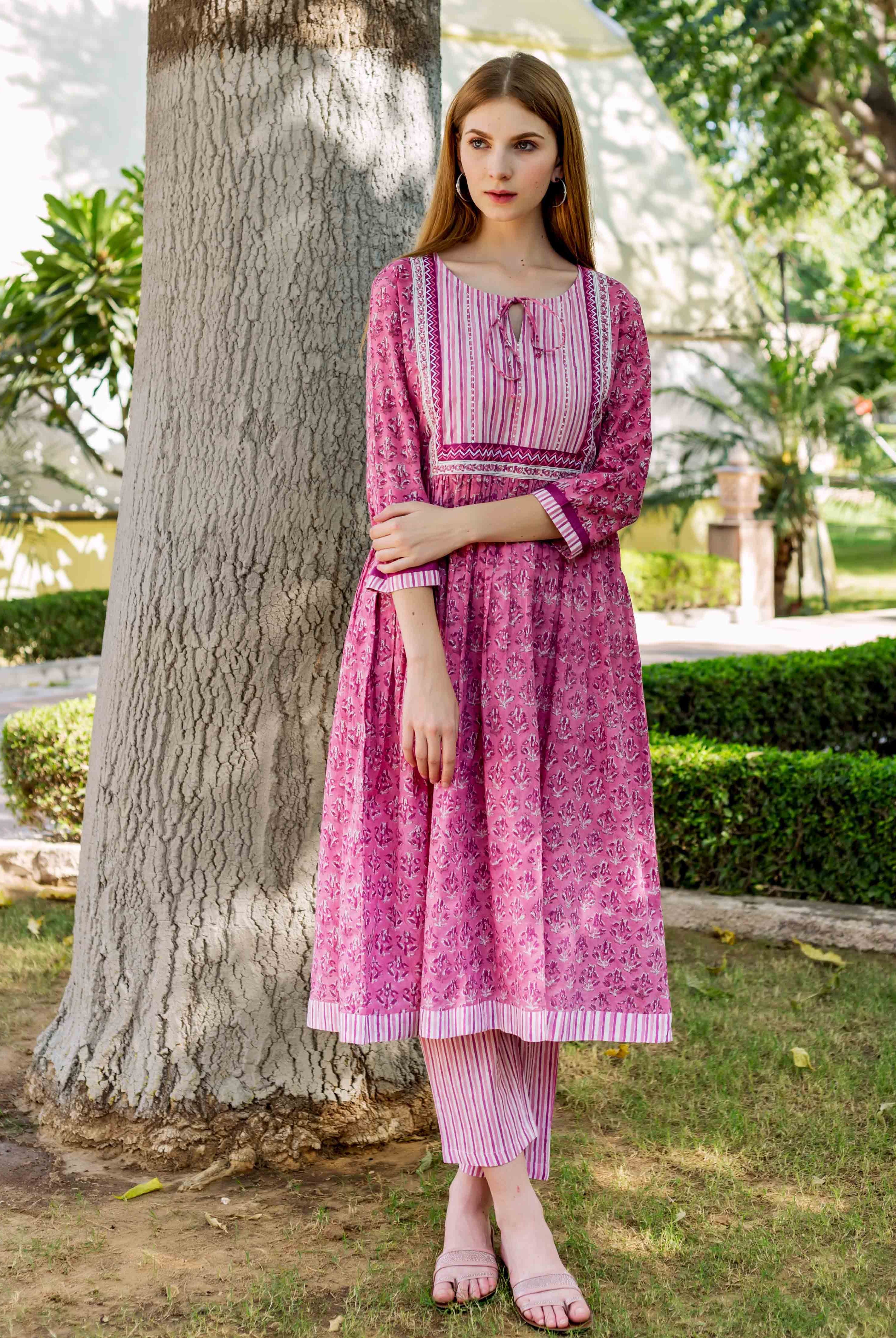 Front view model wearing pink hand-block-printed A-line kurta with striped yoke and pants.