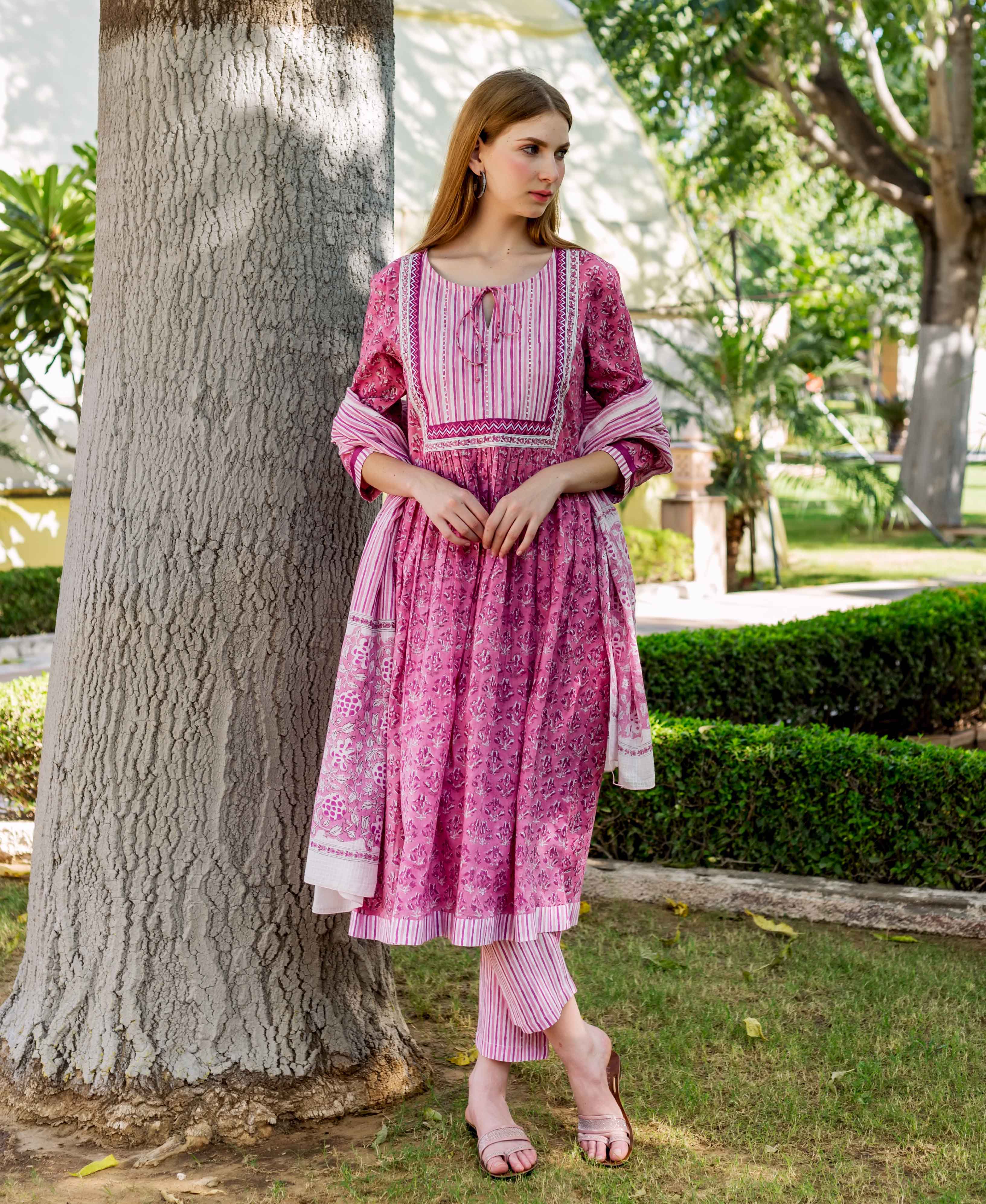 Pink floral hand-block-printed A-line kurta, striped yoke, matching pants, and dupatta on model.