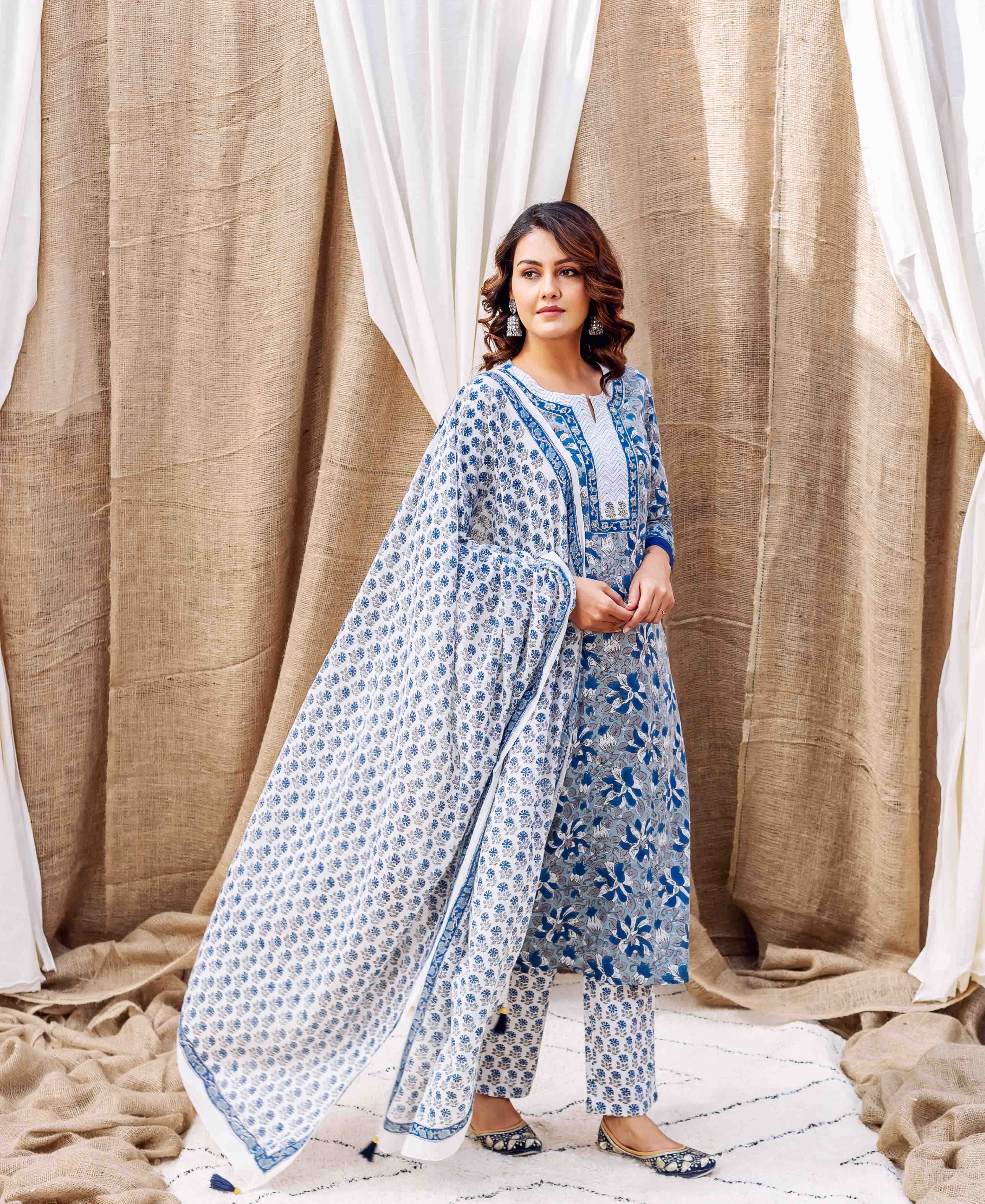 Woman in a blue and white hand-block printed ethnic suit with a flowing dupatta.