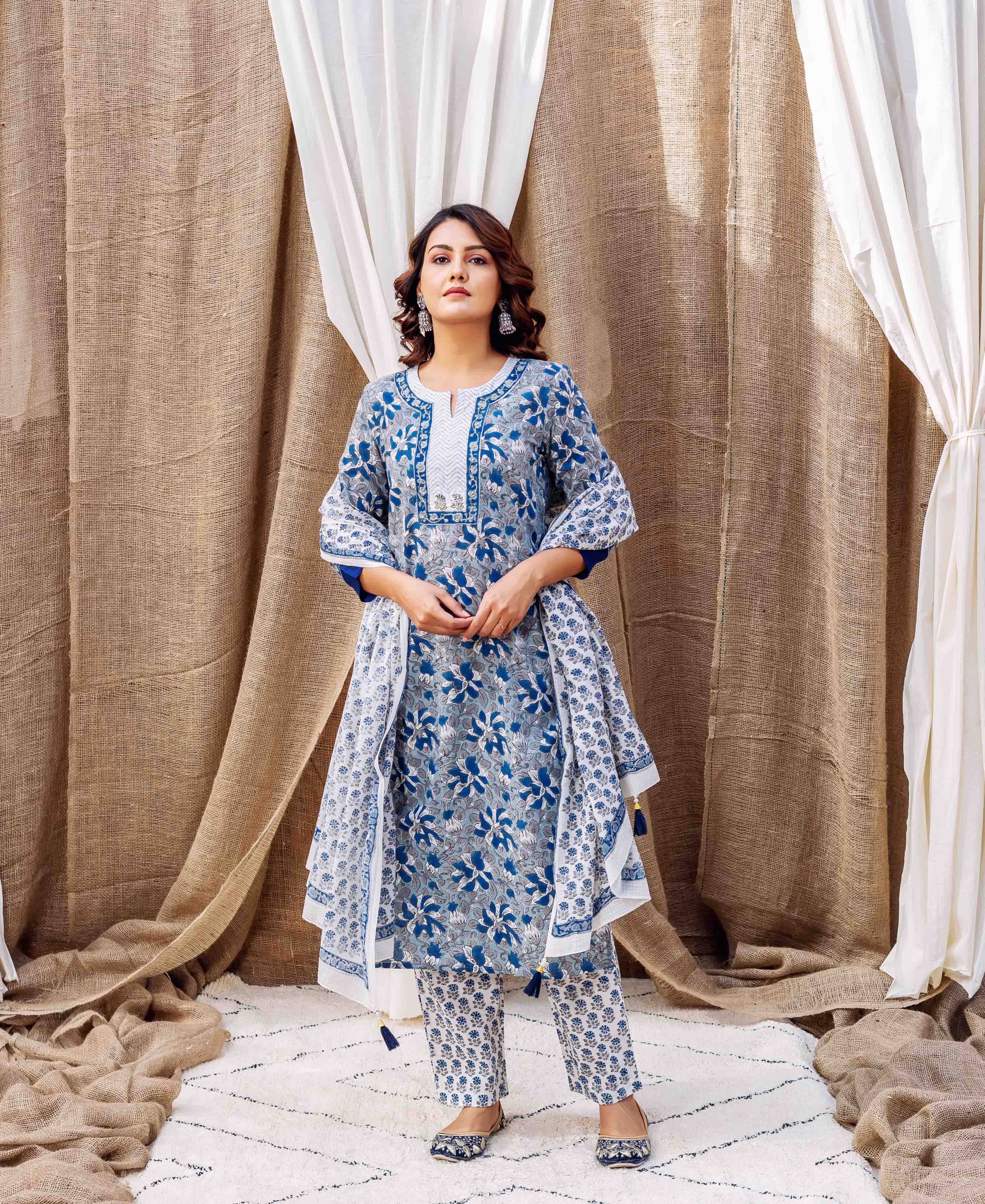 Model in a blue and white floral block-printed kurta set and matching dupatta.