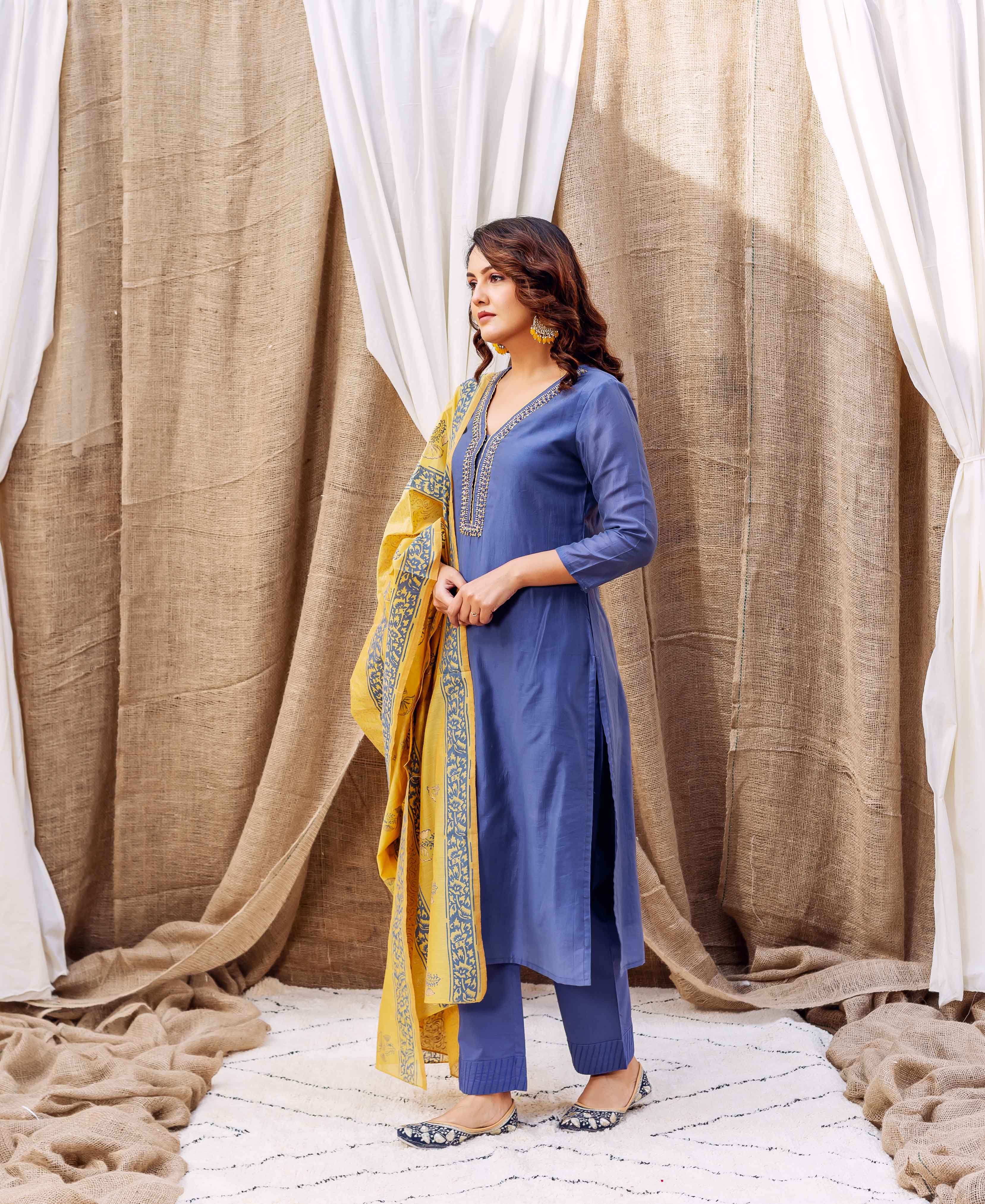 Steel blue hand-block-printed kurta on model with yellow and blue patterned dupatta.
