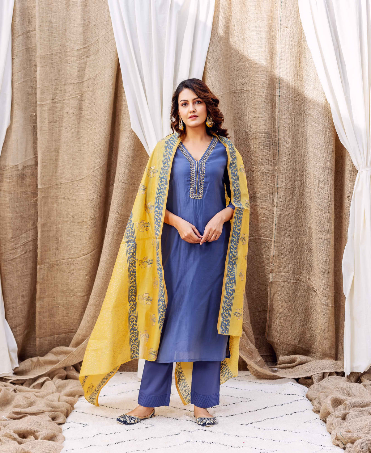 Model wearing steel blue chanderi kurta, matching pants, and yellow hand-block-printed dupatta.