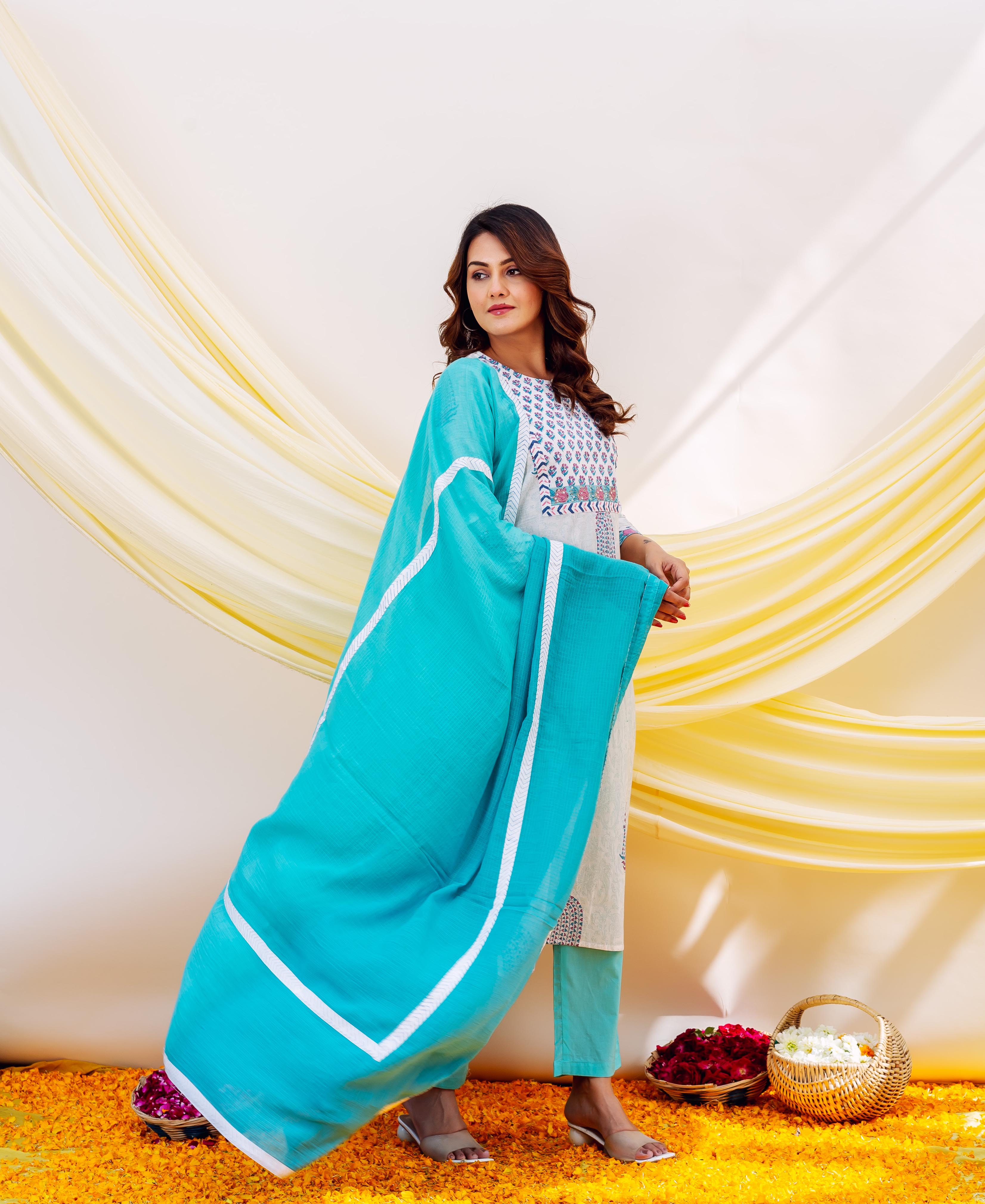 Model posing in aqua blue dupatta with white borders over a white printed kurta.