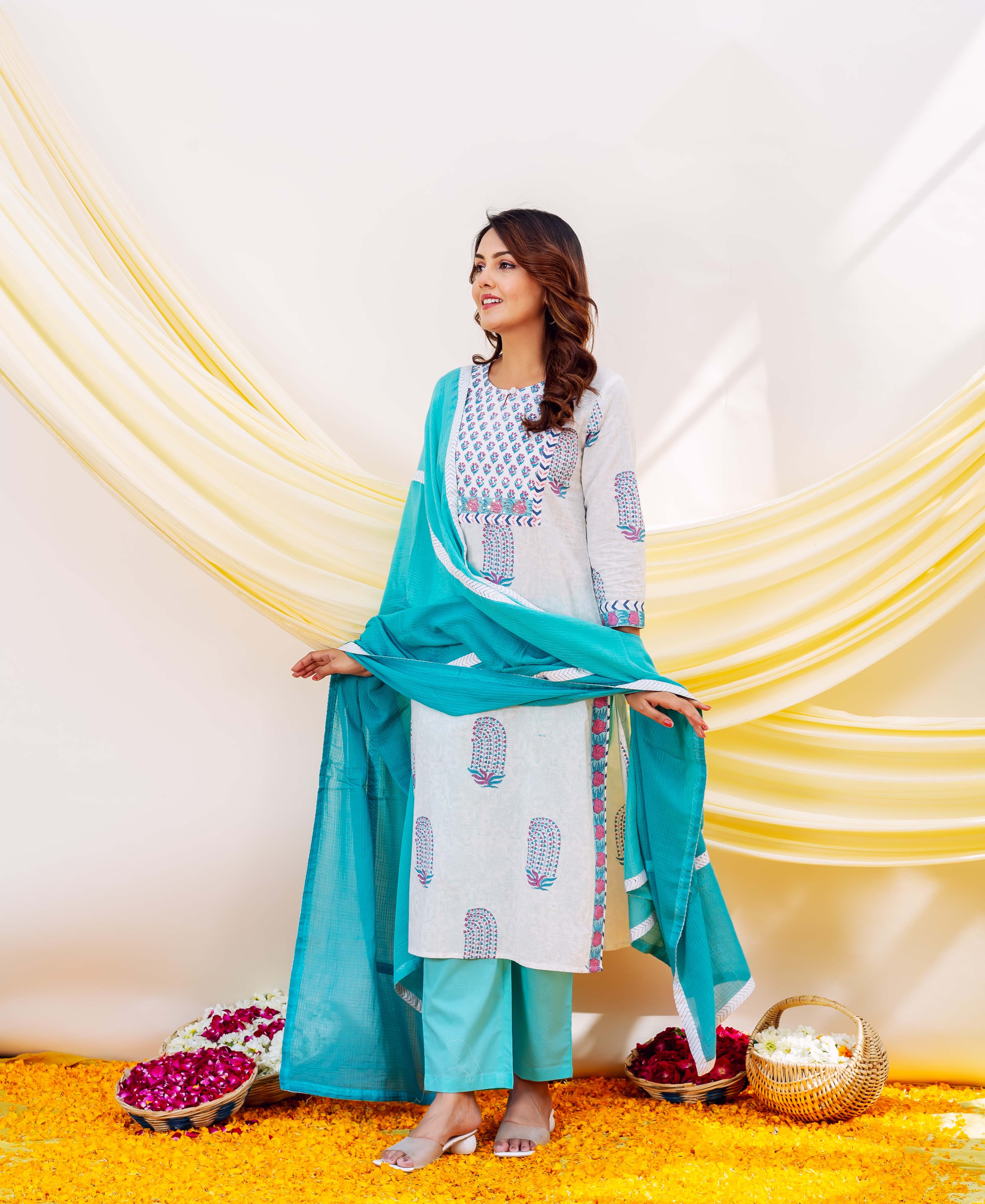 Model in a white hand-block-printed kurta set with a flowing aqua blue Kota Doriya dupatta.