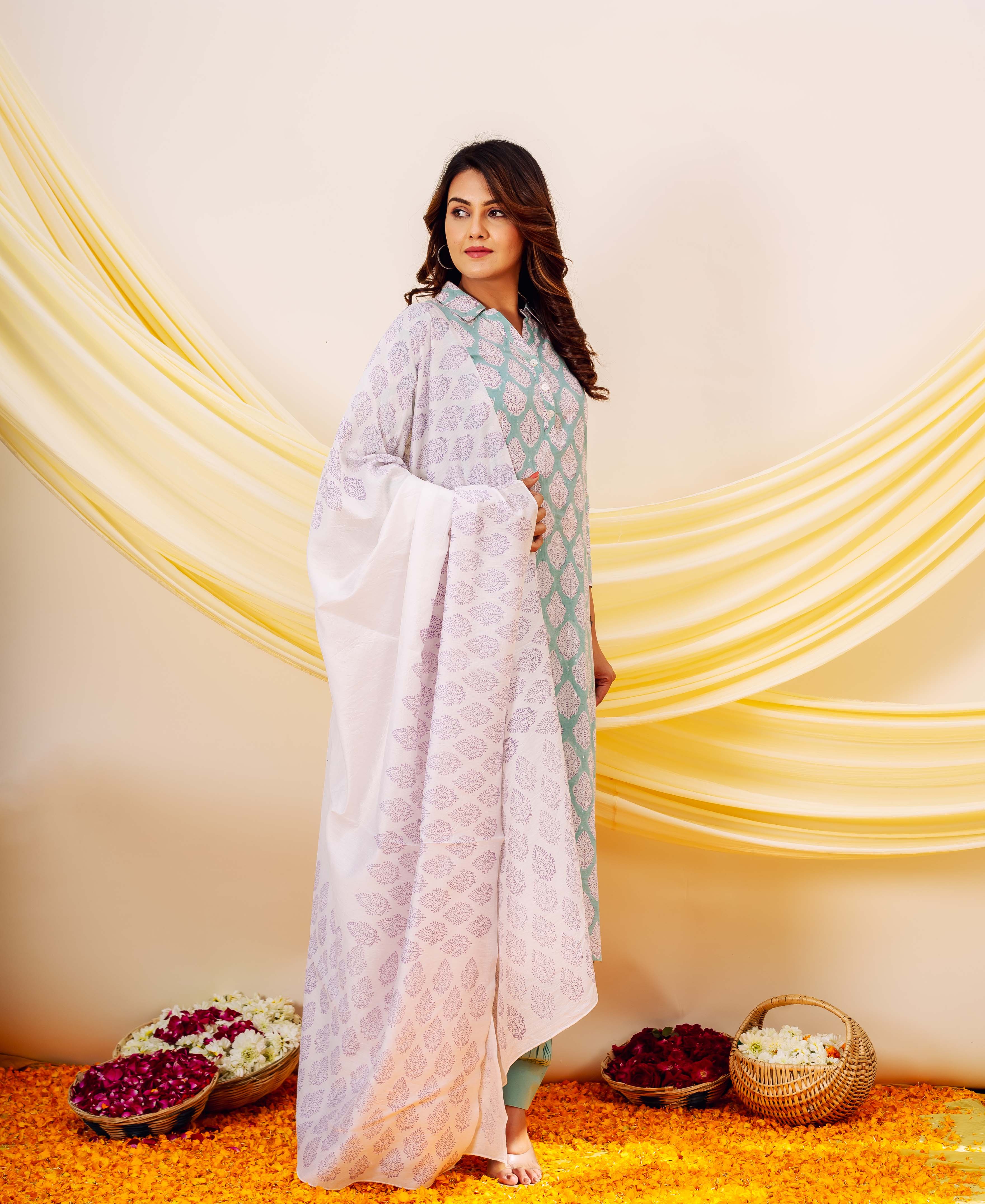 White and purple hand-block printed dupatta with leaf patterns, elegantly draped on a standing model.
