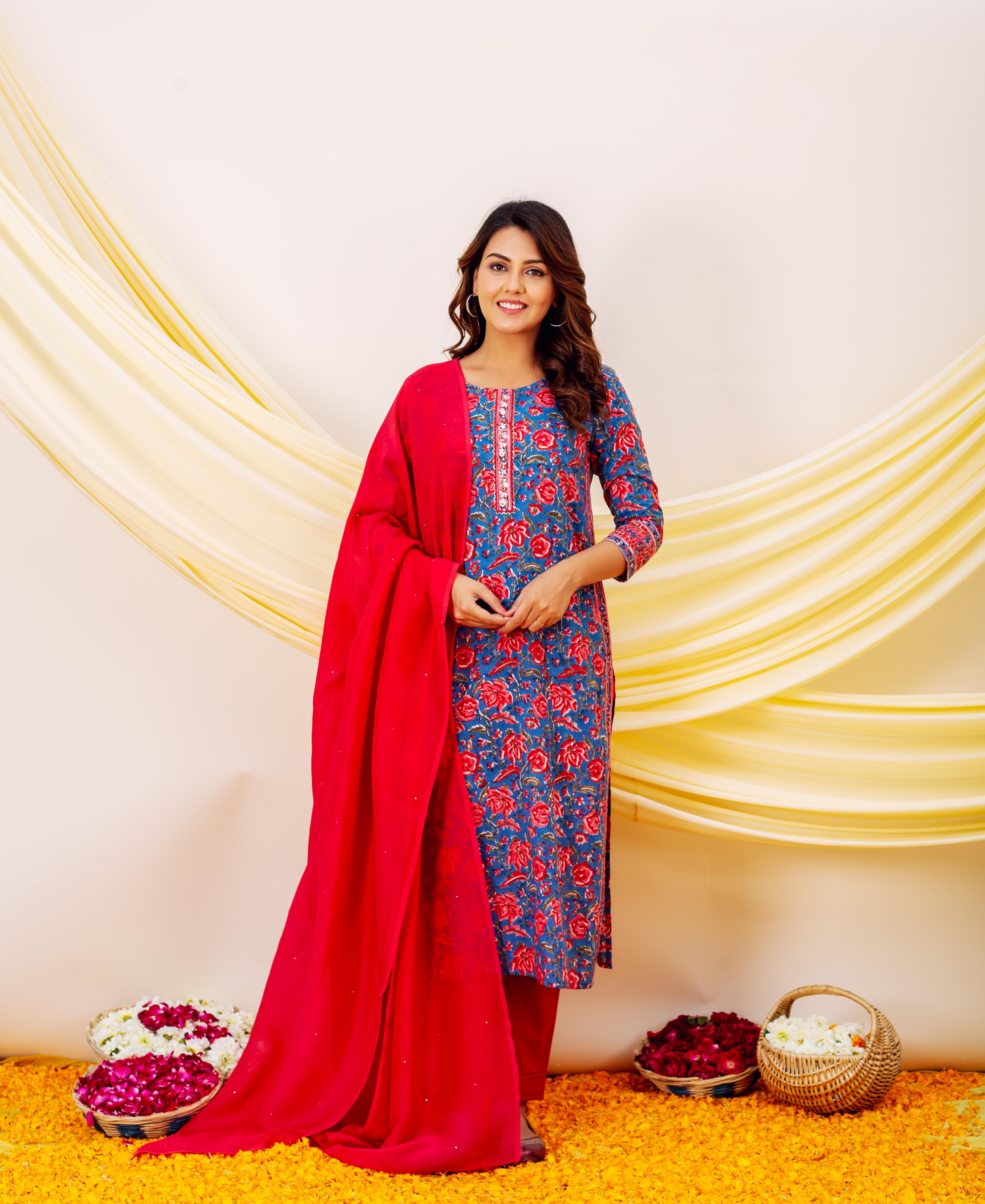Front view of model wearing blue floral embroidered kurta with red dupatta and bottoms.