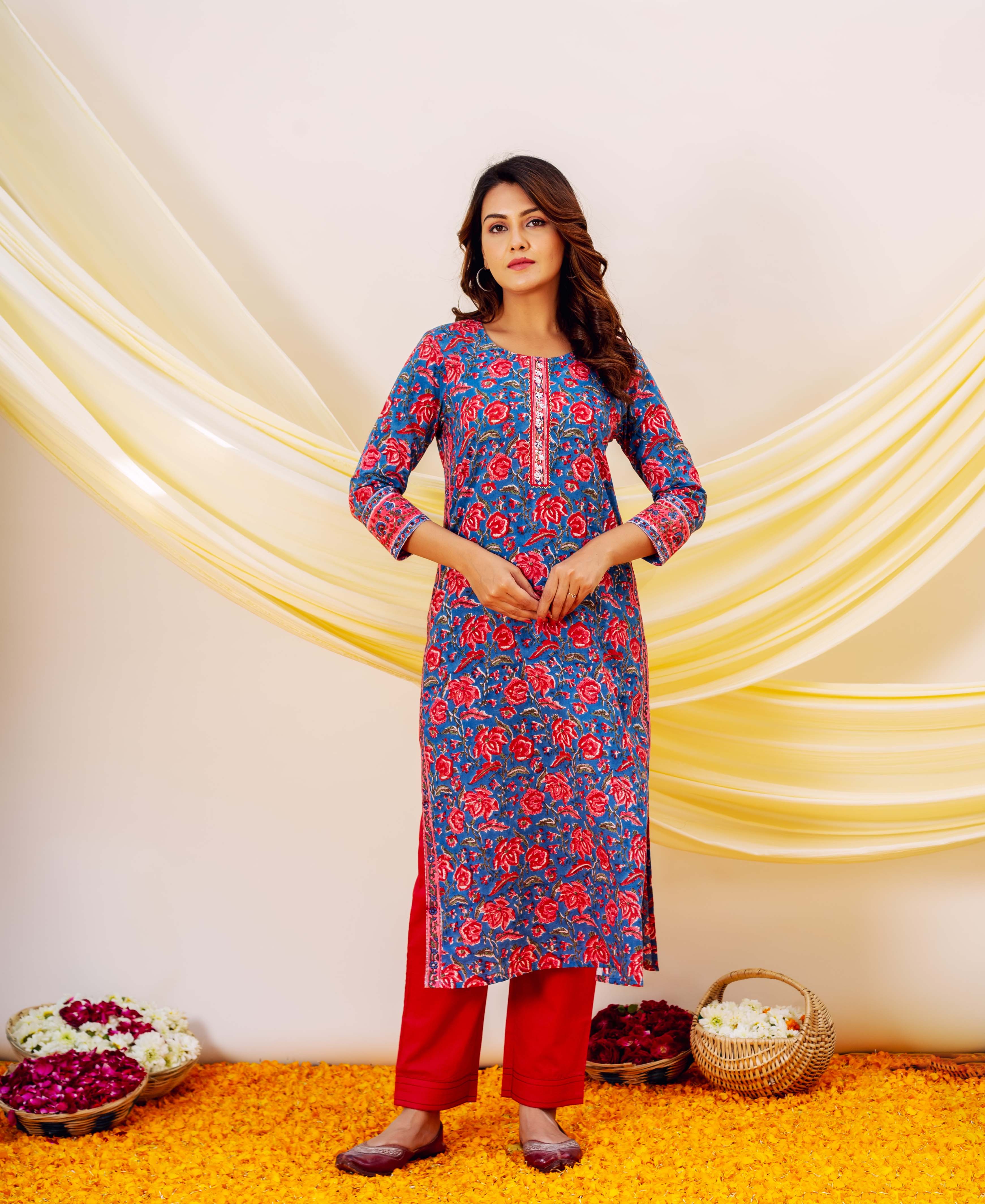 Front view full look of model wearing blue embroidered hand-block-printed floral kurta with red bottoms.