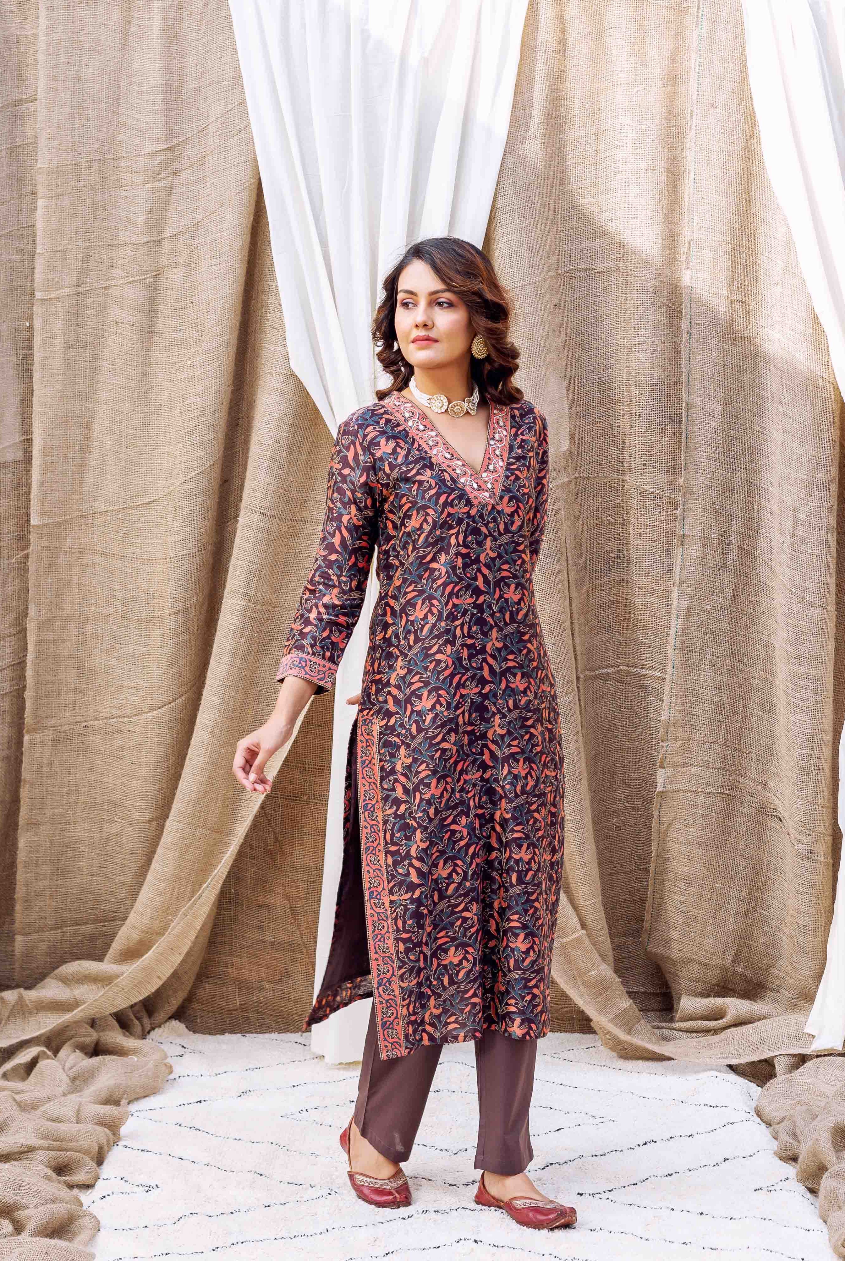 Model in front view wearing a dark hand-block printed kurta with orange and blue floral print.