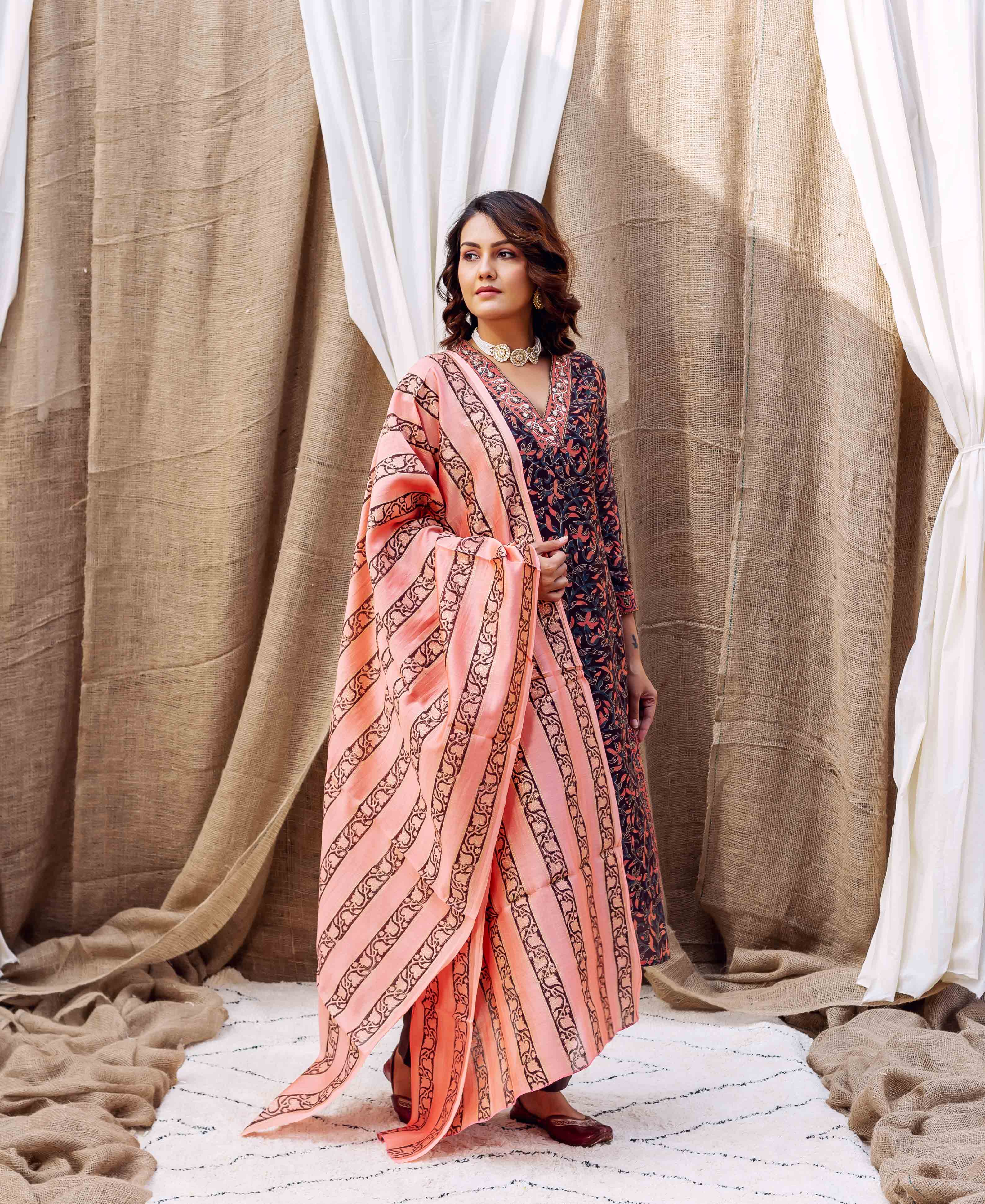 Model wearing light rust and brown hand block printed dupatta with striped patterns.