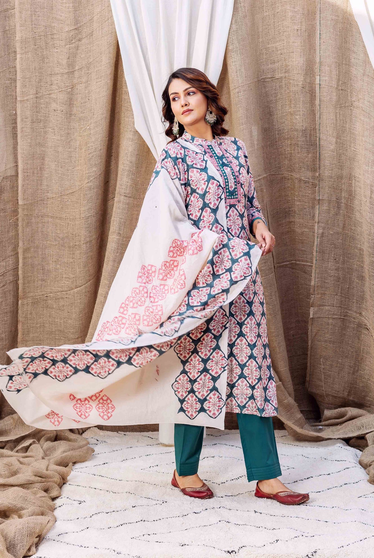 A model wearing a teal green block-printed kurta with a white dupatta.