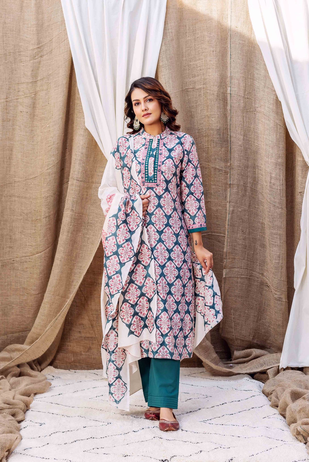 A model wearing a teal green block printed chanderi kurta with a floral pattern.
