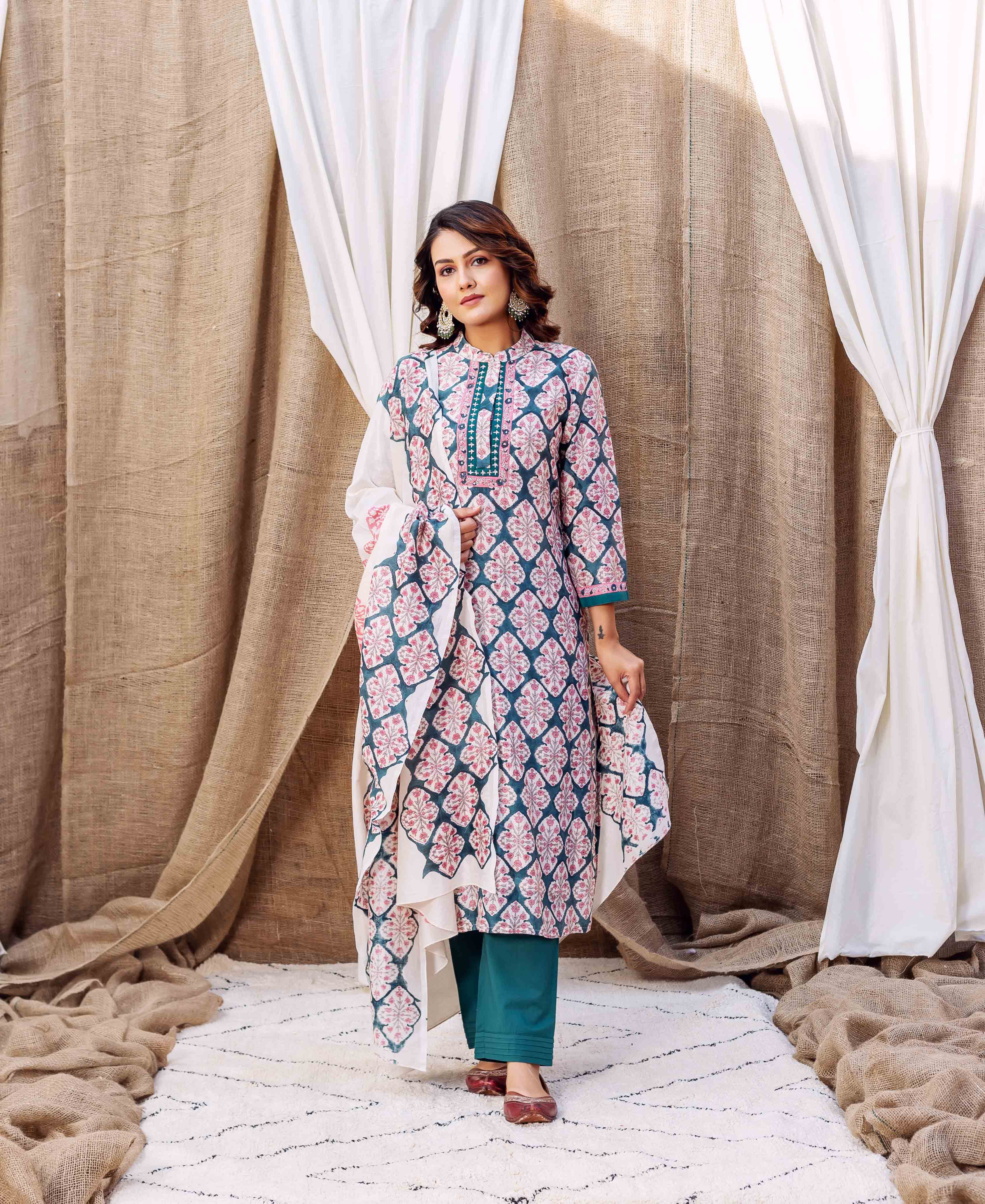 A model wearing a teal green block printed chanderi kurta with a floral pattern.