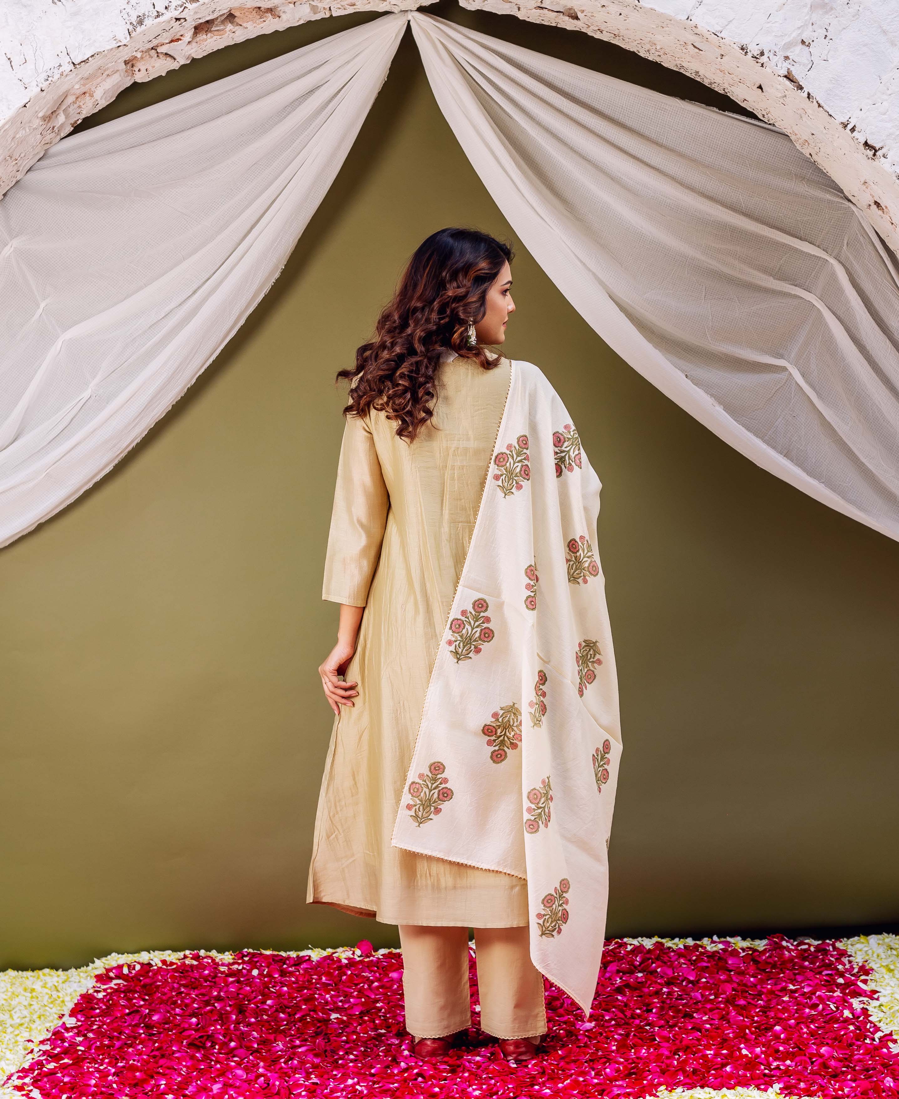 Model from back in serene olive kurta set, cream dupatta with red floral block print.