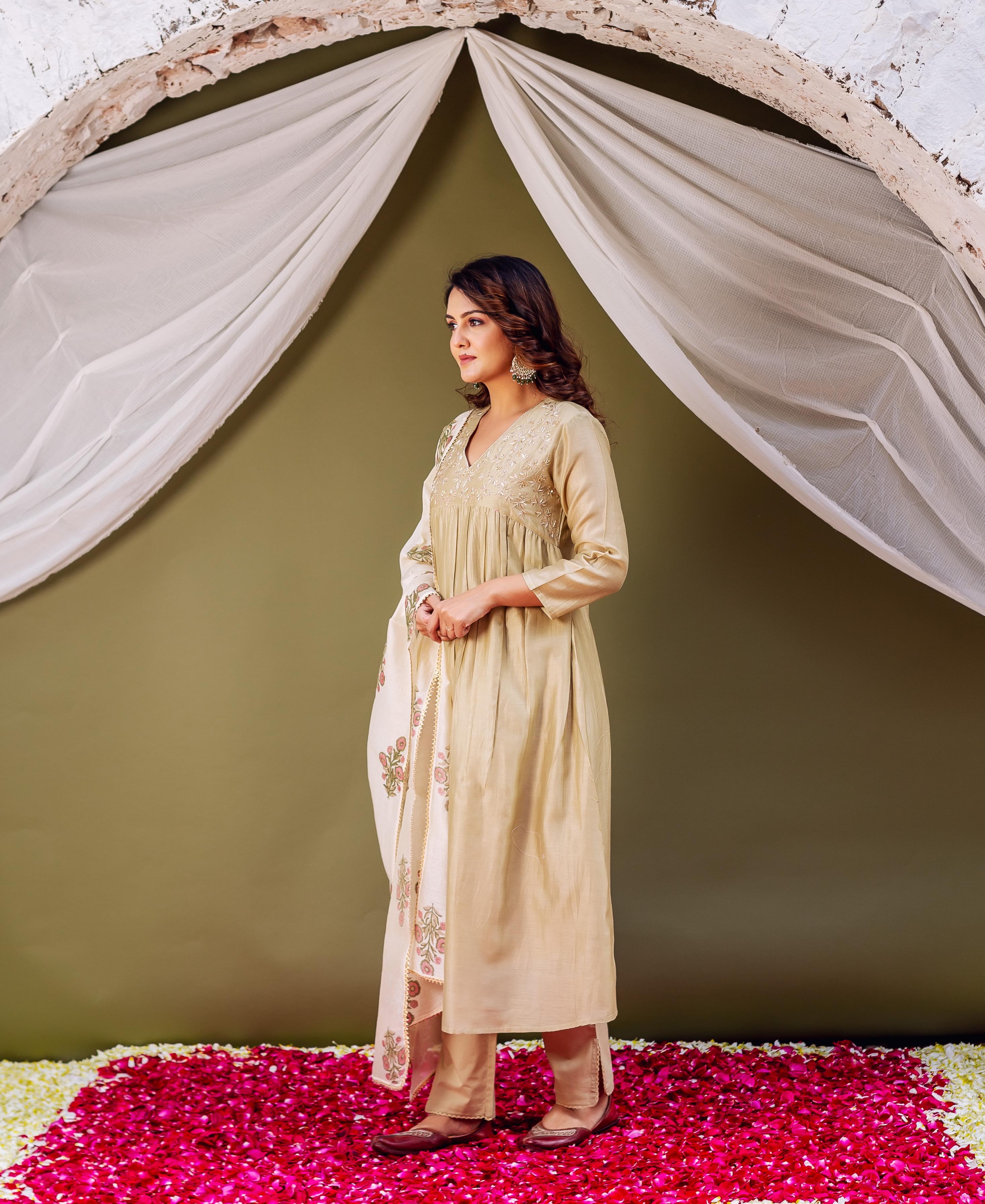 Full body model in a light golden embroidered kurta with a floral hand-block printed dupatta.