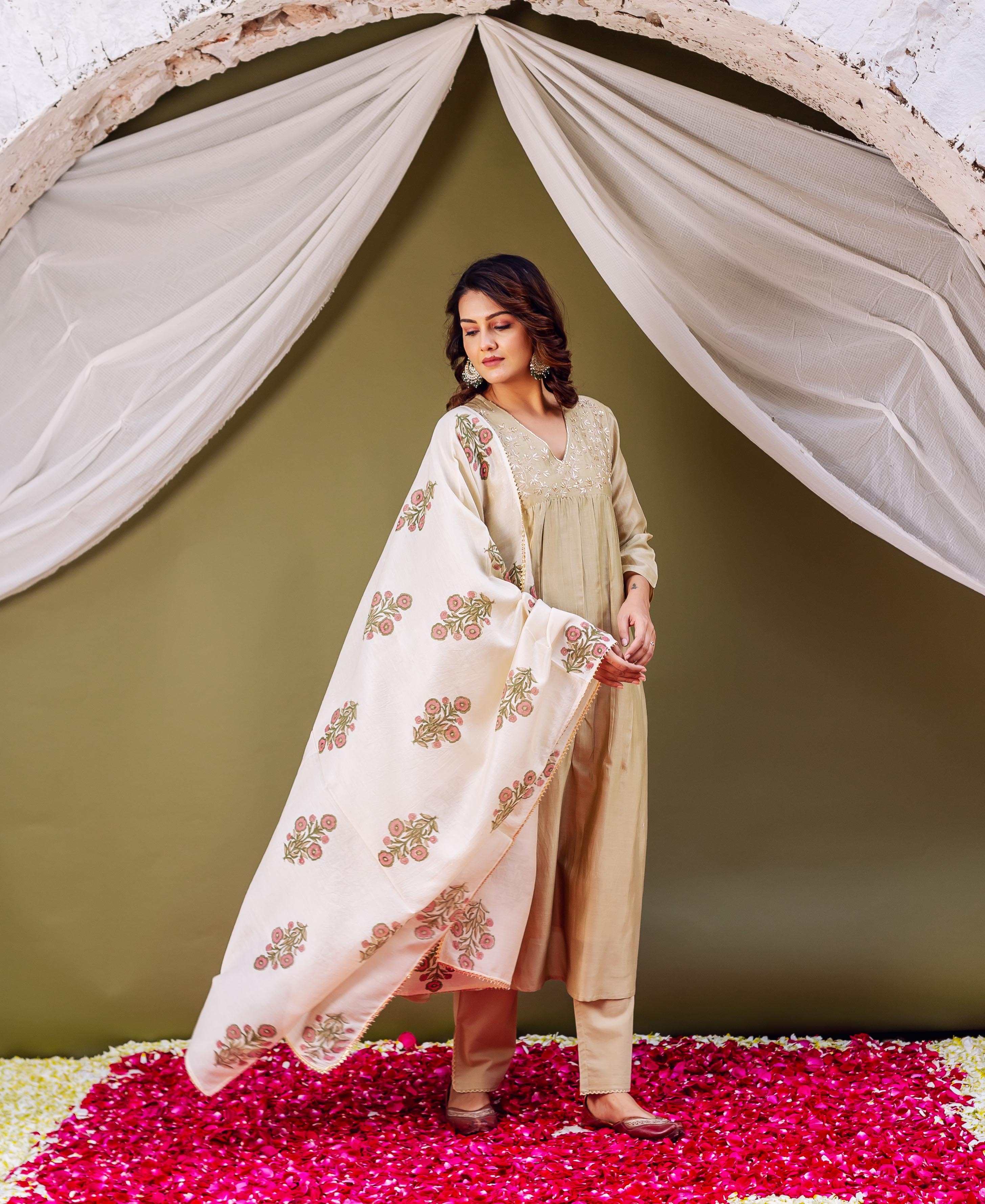 Model wears light olive embroidered kurta set with cream floral block-printed dupatta.