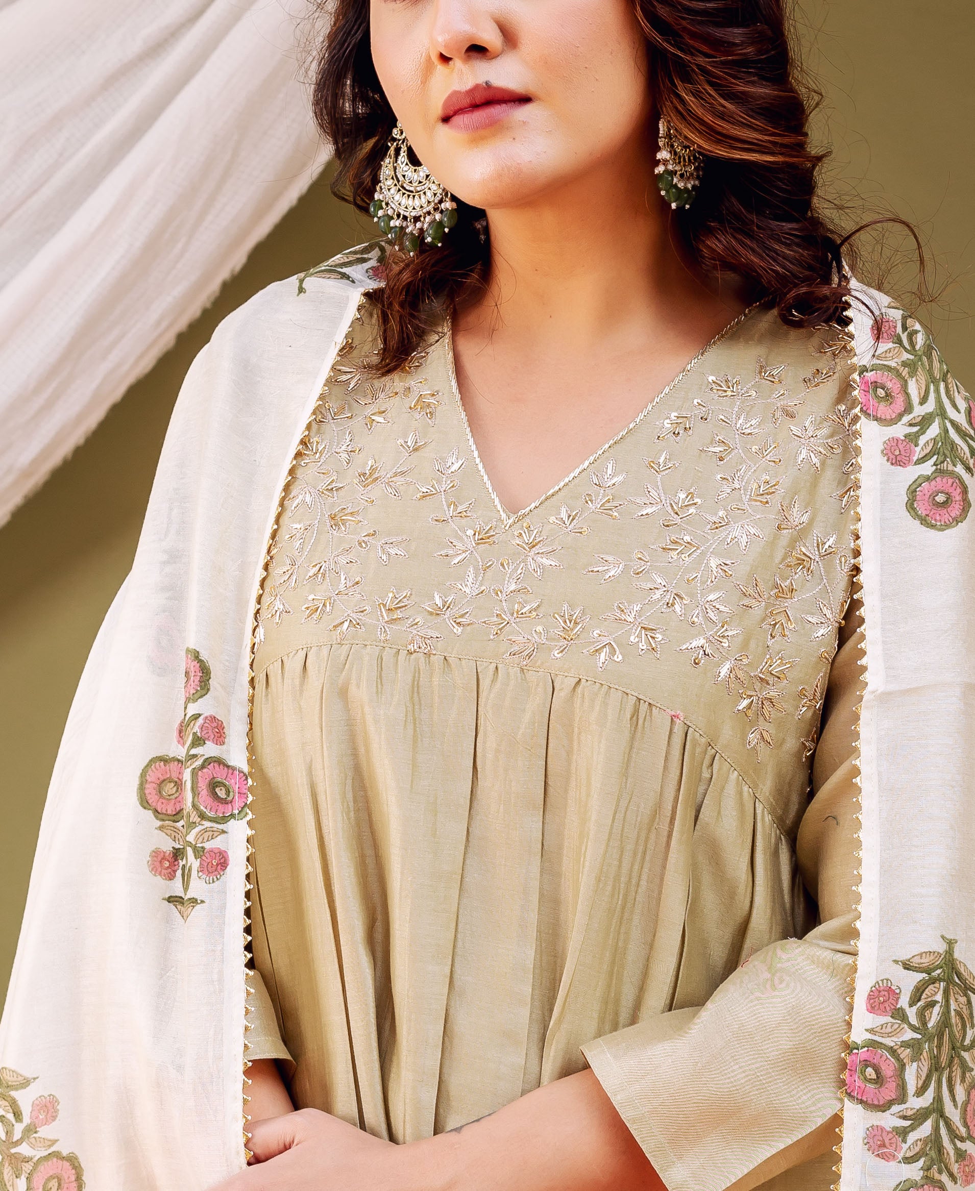 Close-up of model wearing an olive embroidered kurta with a floral block-printed cream dupatta.