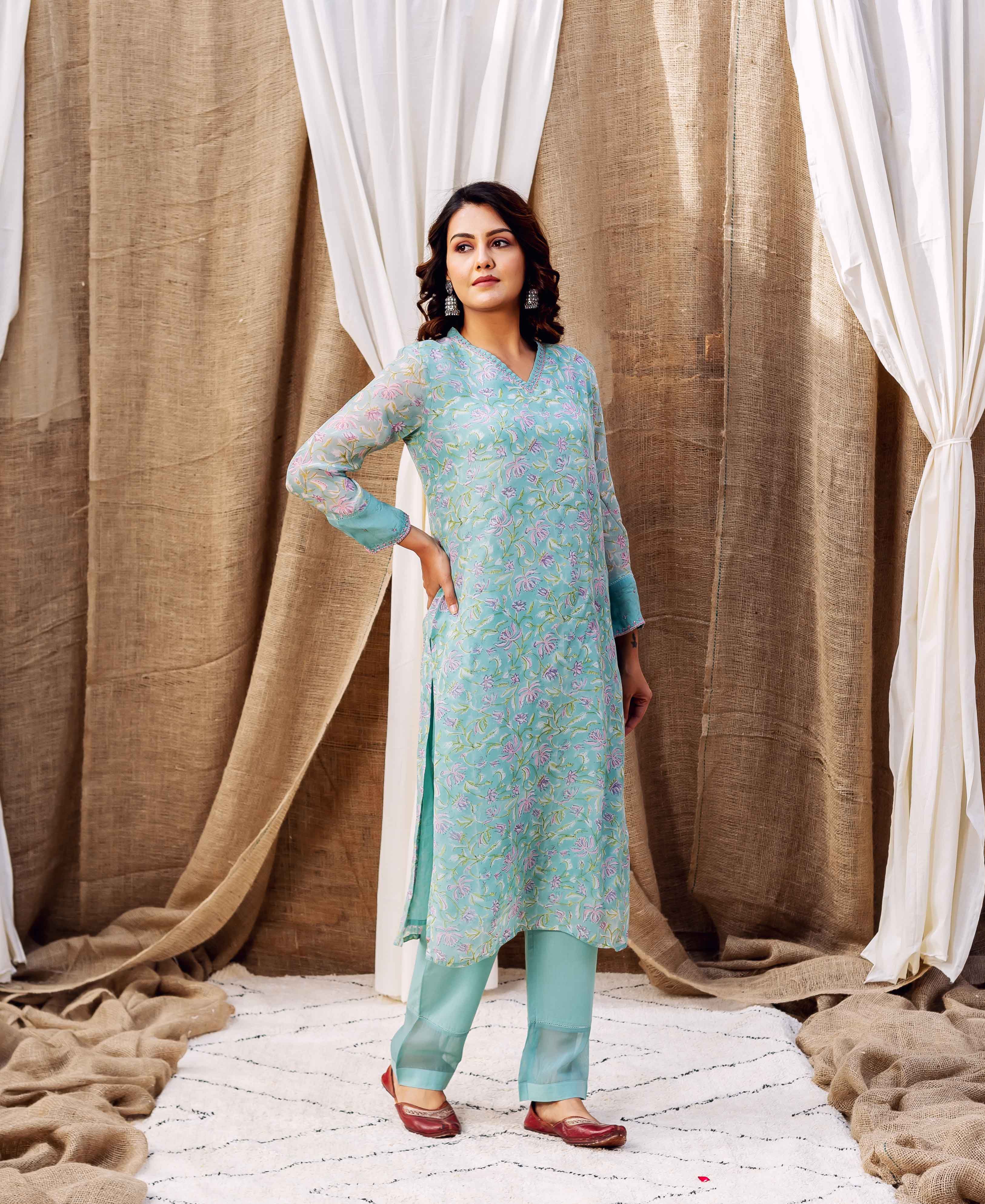 Model in a full-length turquoise floral block-printed kurta set.