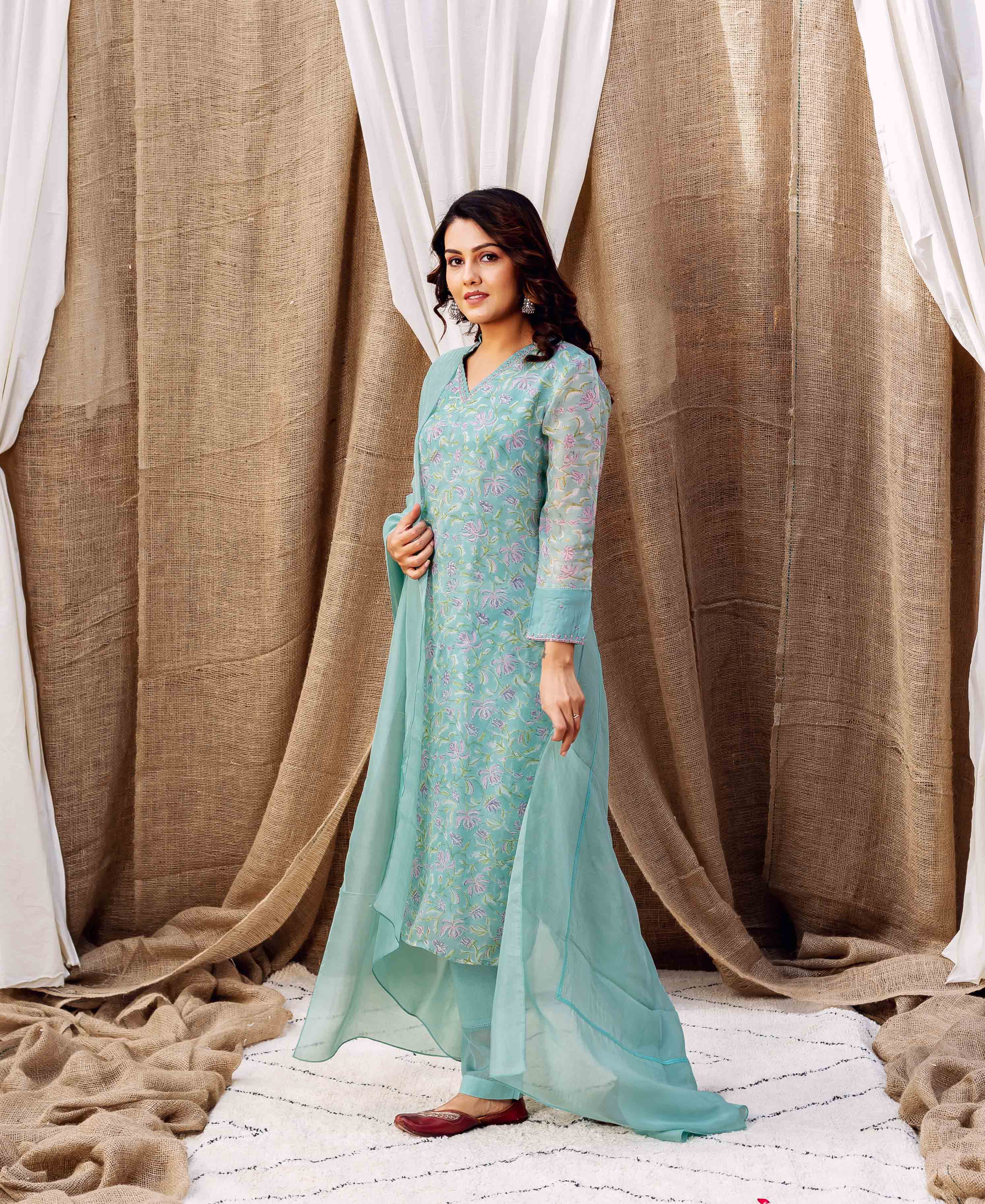 Full-length model in turquoise organza kurta set with delicate floral hand-block print.