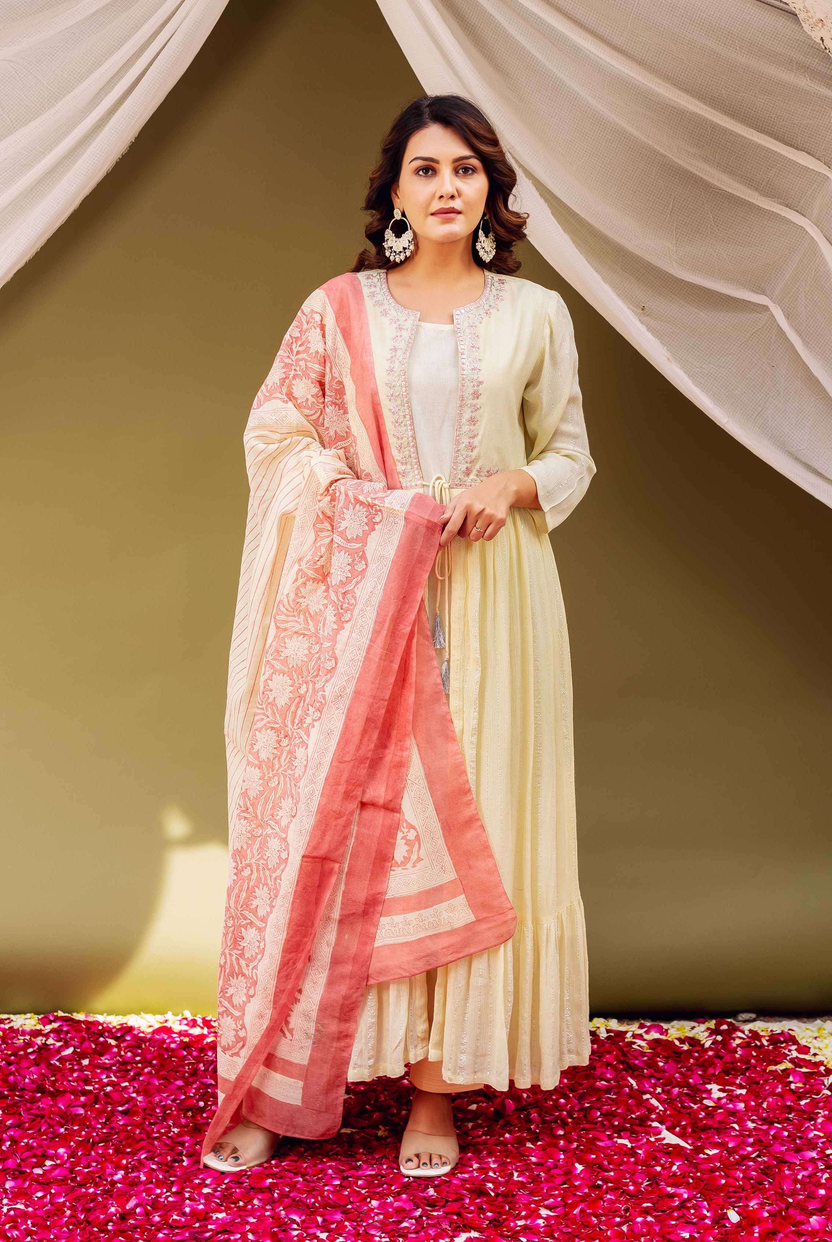 Woman modeling a pale yellow jacket-style kurta and a hand-block-printed coral and cream dupatta.