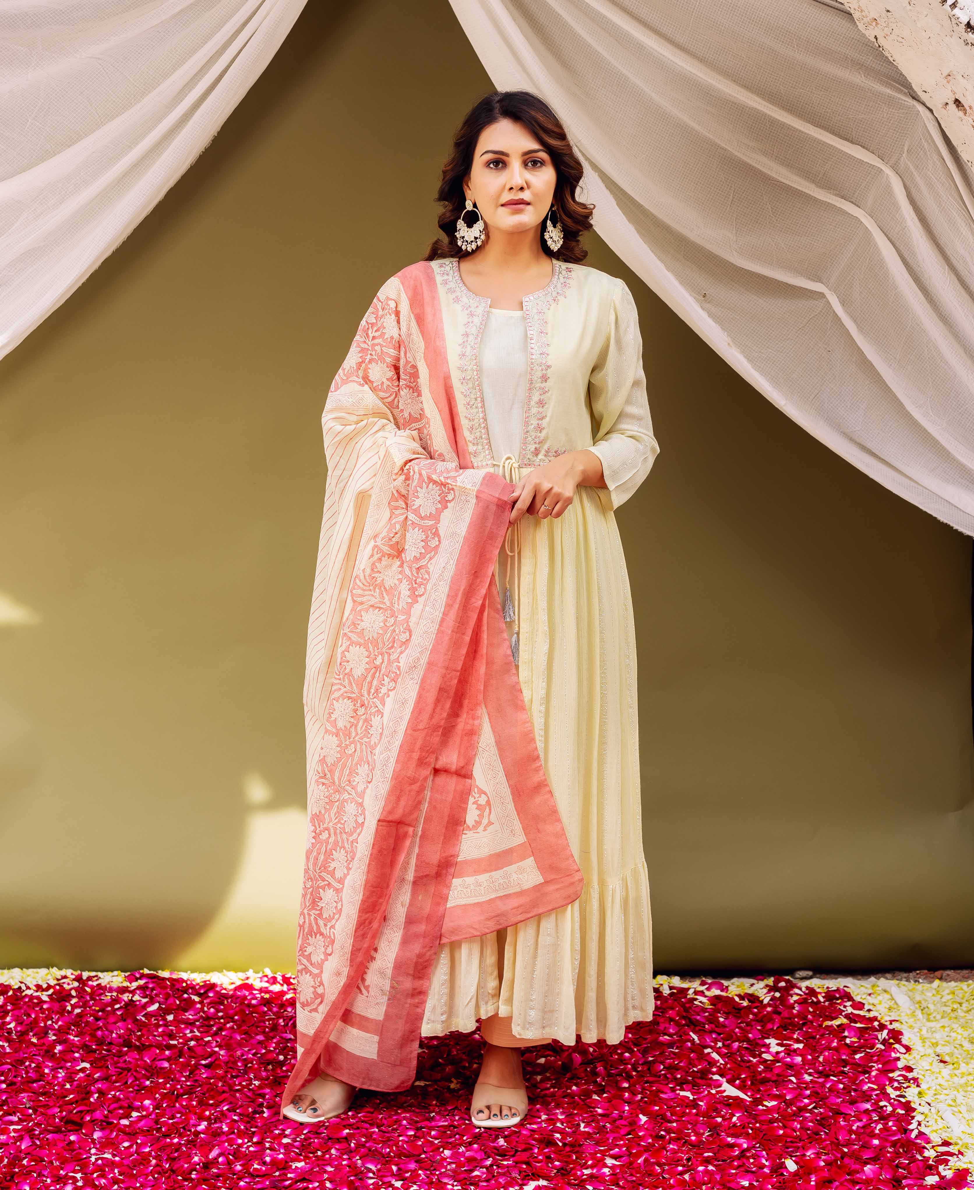 Woman modeling a pale yellow jacket-style kurta and a hand-block-printed coral and cream dupatta.