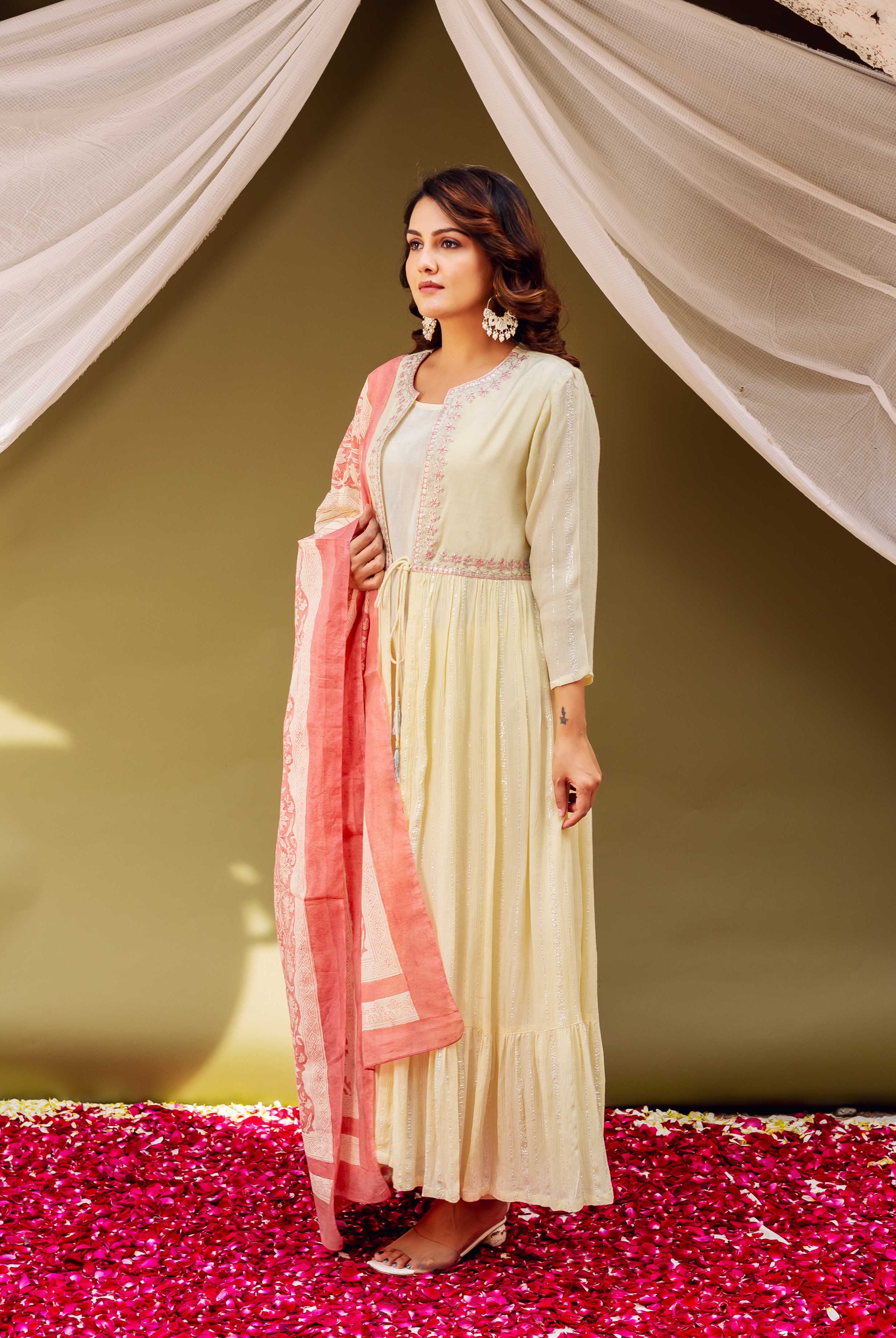 Model in cream shimmer jacket style ethnic kurta with peach hand-block-printed dupatta.