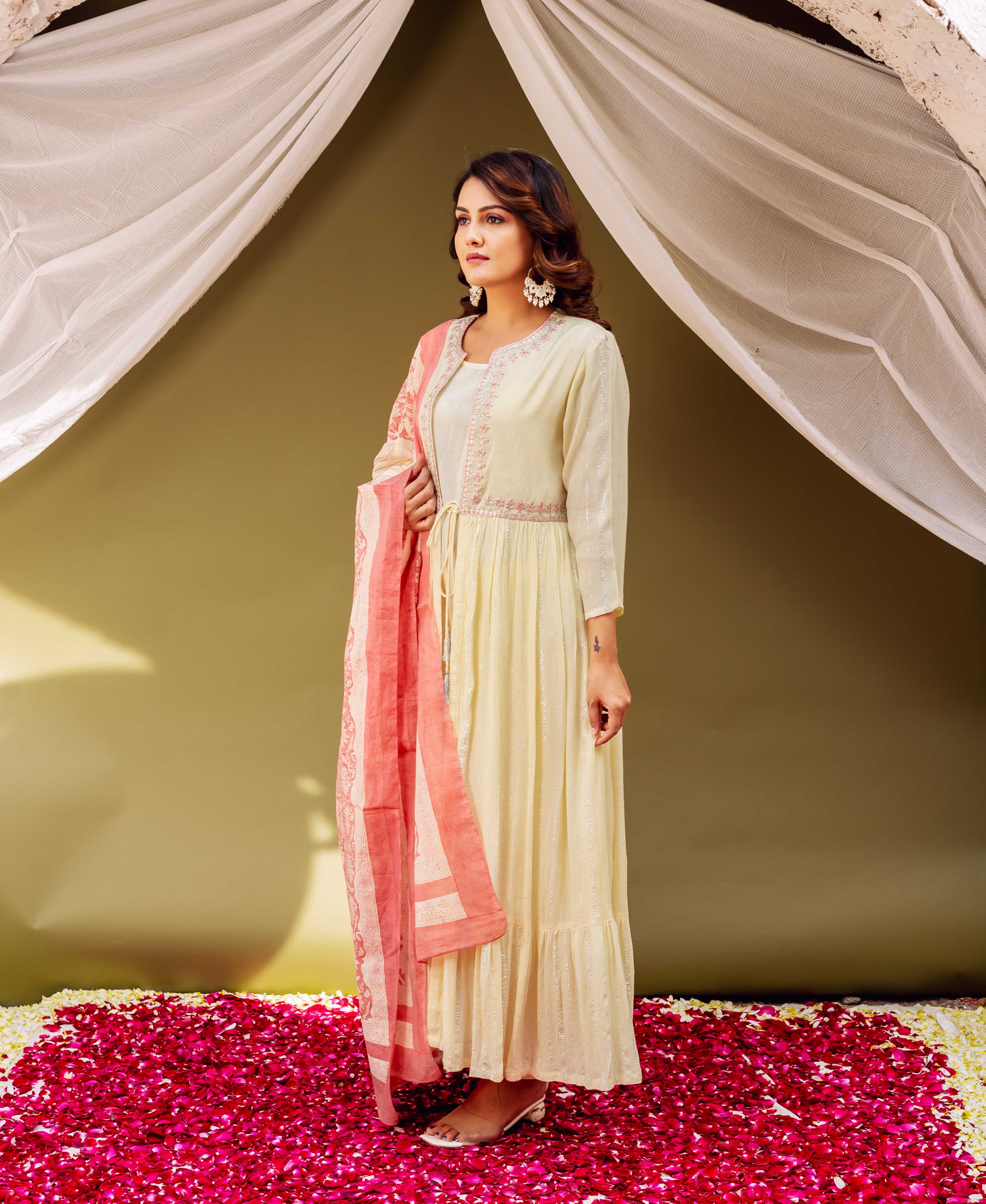 Model in cream shimmer jacket style ethnic kurta with peach hand-block-printed dupatta.