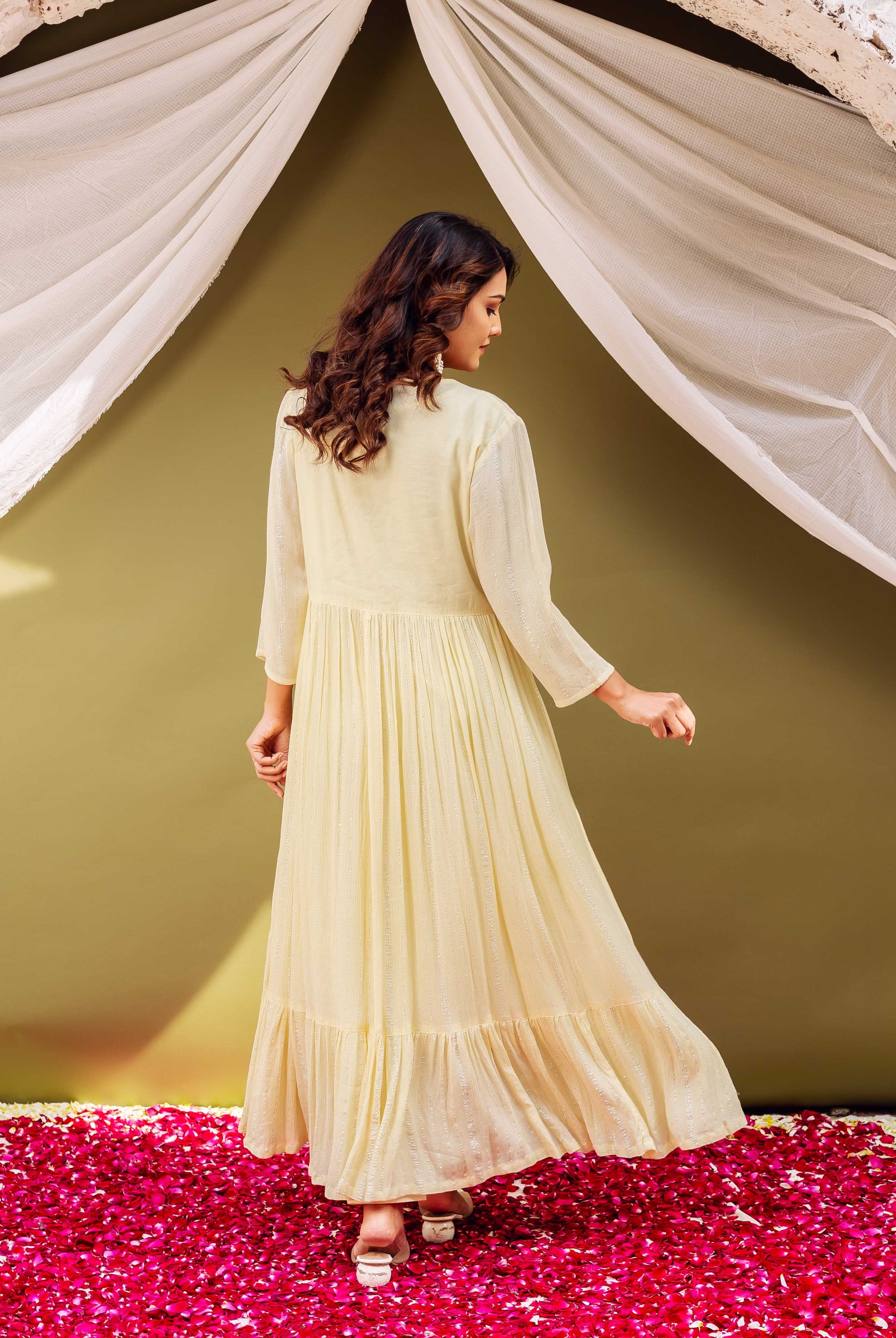 Back view of model in a light yellow shimmering long-sleeved pleated kurta.