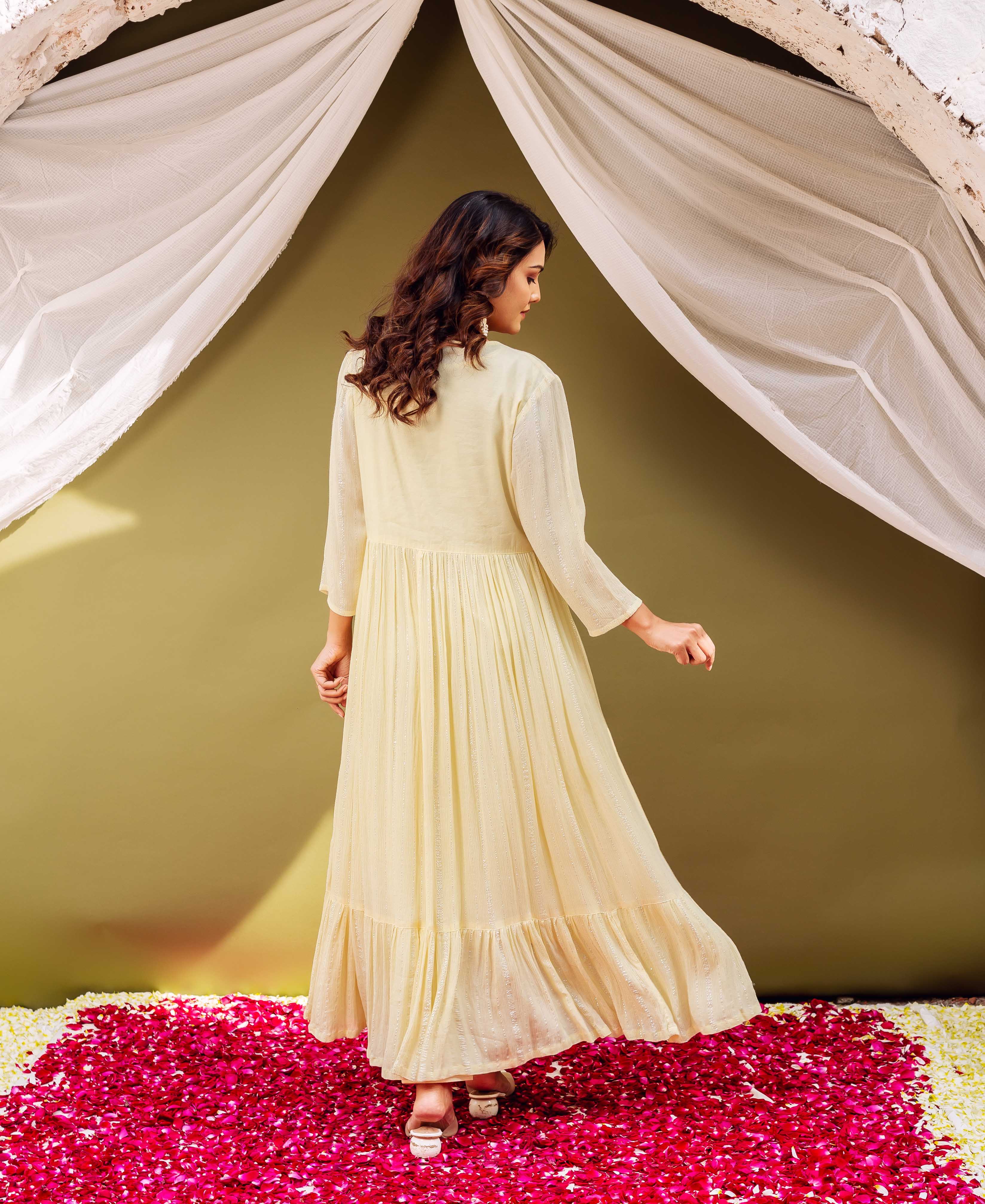 Back view of model in a light yellow shimmering long-sleeved pleated kurta.